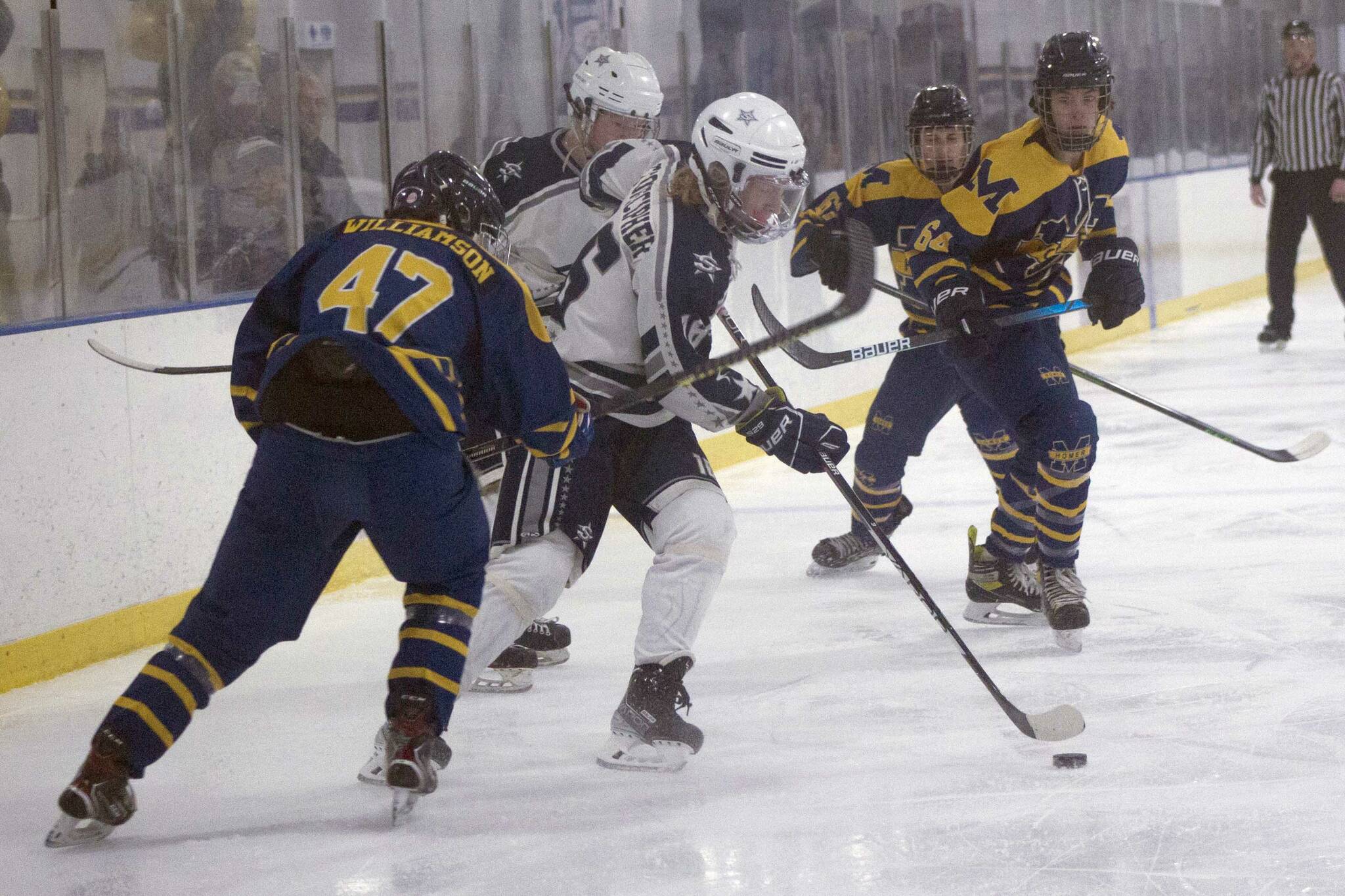 Soldotna's Landon Stonecipher carries the puck against Homer on Friday, Jan. 14, 2022, at Kevin Bell Ice Arena in Homer, Alaska. (Photo by Sarah Knapp/Homer News)