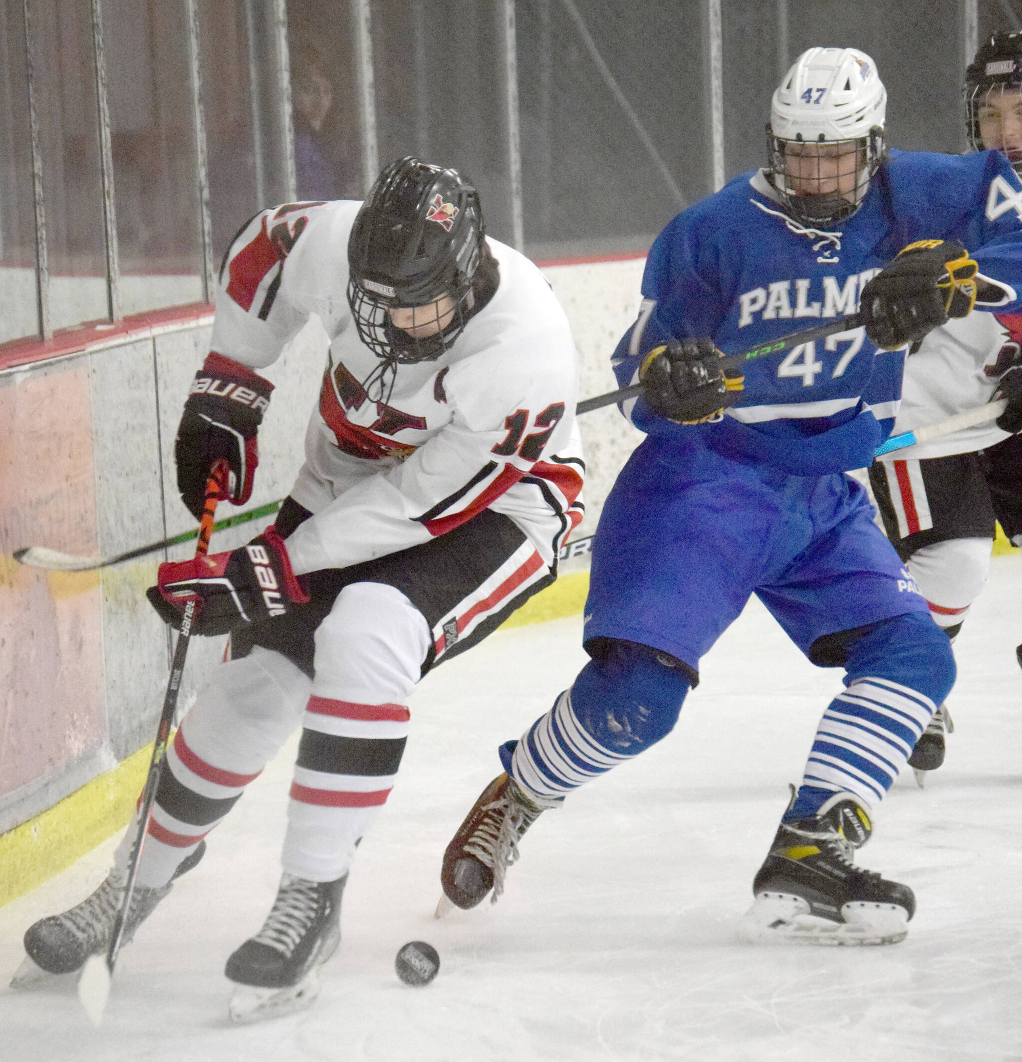 Kenai’s Landon Cialek and Palmer’s Joseph Samaniego battle for the puck Friday, Jan. 21, 2022, at the Kenai Multi-Purpose Facility in Kenai, Alaska. (Photo by Jeff Helminiak/Peninsula Clarion)