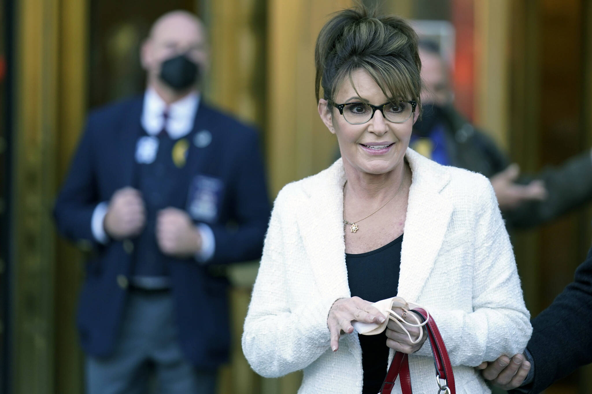 Sarah Palin leaves the courthouse in New York, Thursday, Feb. 10, 2022. Former Alaska Gov. Sarah Palin told a jury Thursday she felt like she was at the mercy of a “Goliath” when she first learned a 2017 New York Times editorial suggested her campaign rhetoric helped incite a mass shooting. (AP Photo/Seth Wenig)