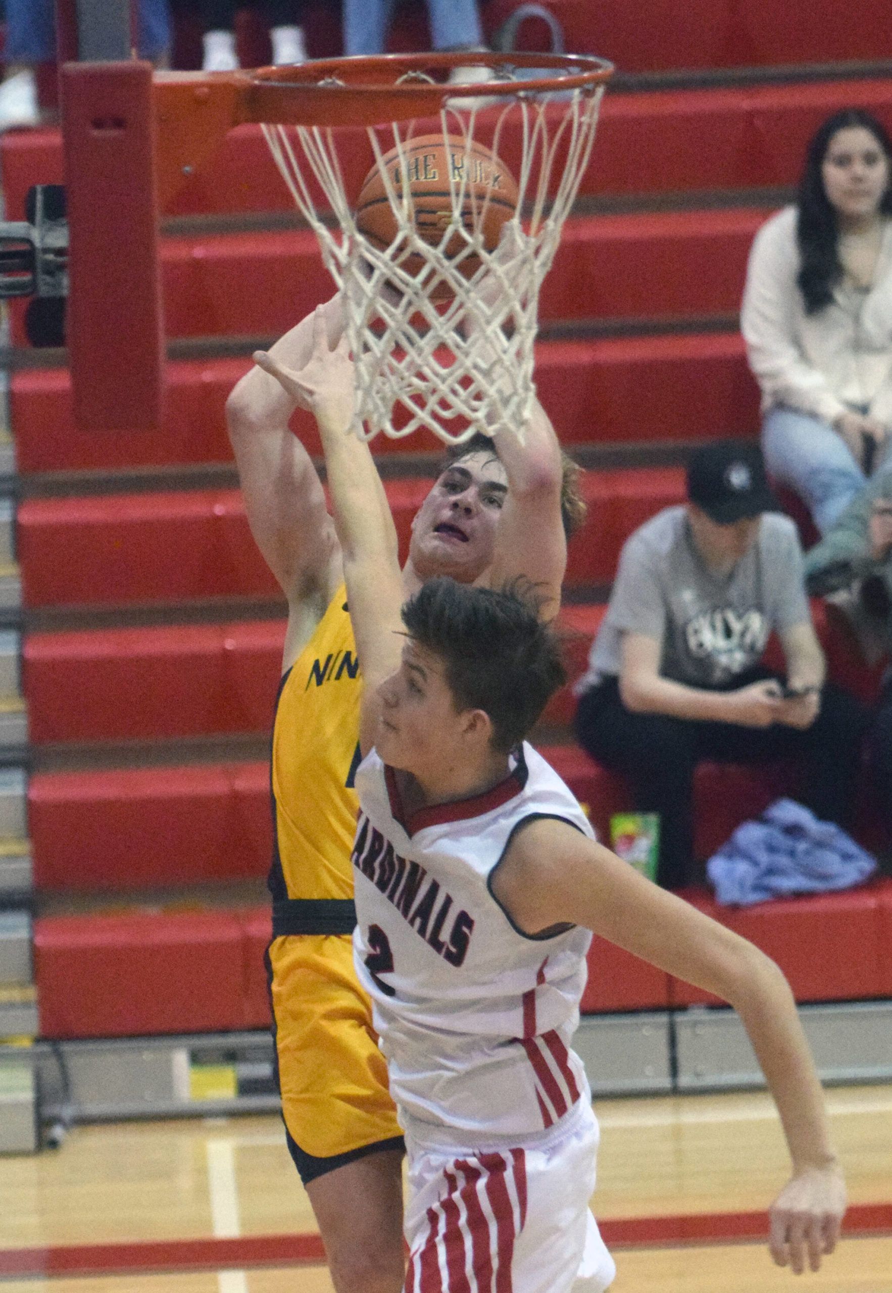 Ninilchik’s Landon Colburn drives on Kenai Central’s Eli McCubbins on Saturday, March 5, 2022, at Kenai Central High School in Kenai, Alaska. (Photo by Jeff Helminiak/Peninsula Clarion)