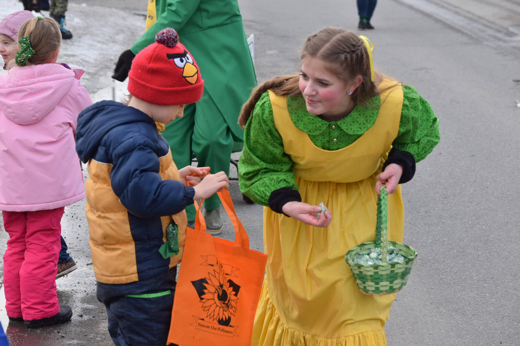 Kids line the streets in Soldotna during the Sweeney’s St. Patrick’s Parade on March 17, 2022. (Camille Botello/Peninsula Clarion)