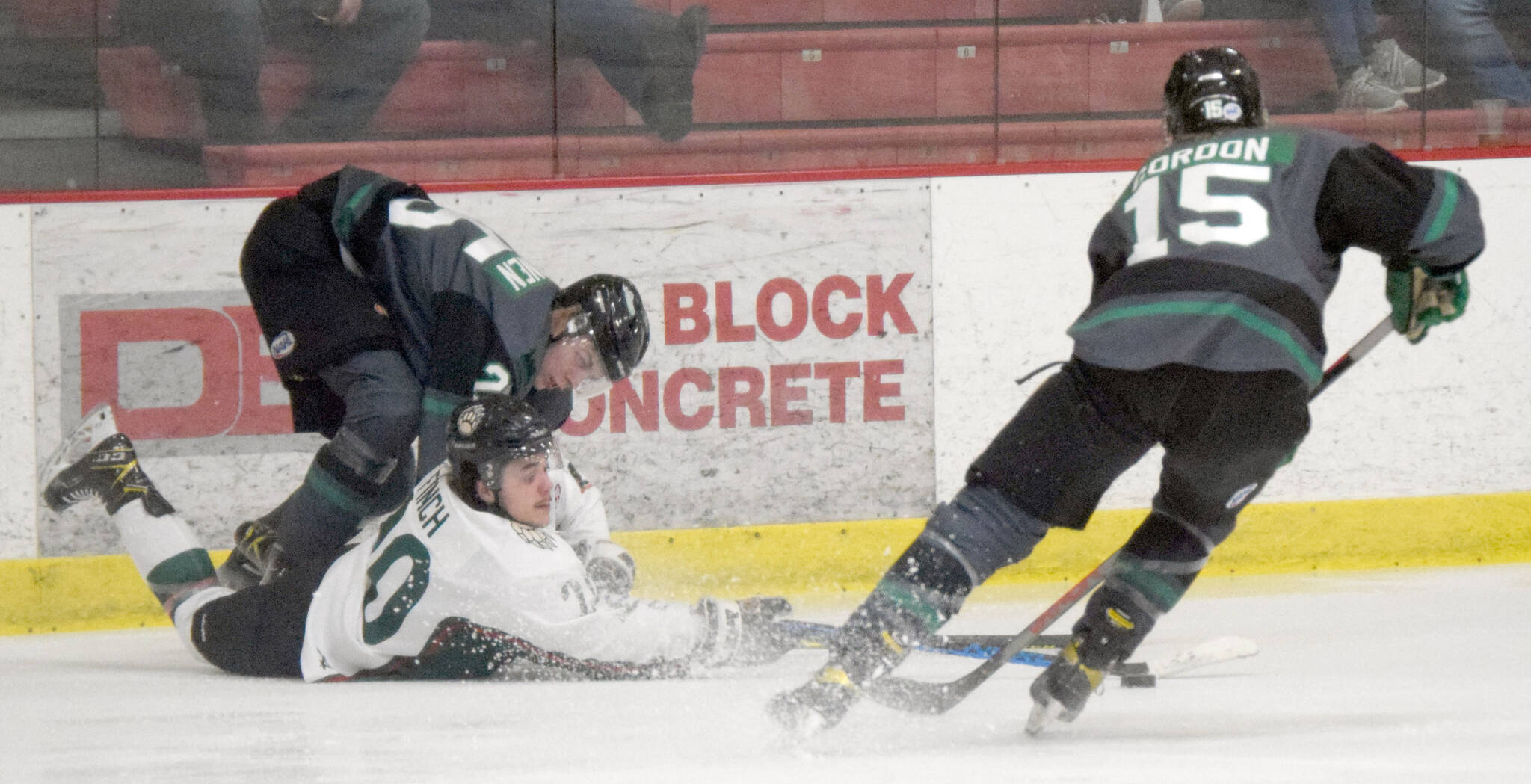 Kenai River Brown Bears forward Ryan Finch battles Minnesota Wilderness defenseman Severi Sulonen and forward Cole Gordon for the puck Friday, March 18, 2022, at the Soldotna Regional Sports Complex in Soldotna, Alaska. (Photo by Jeff Helminiak/Peninsula Clarion)