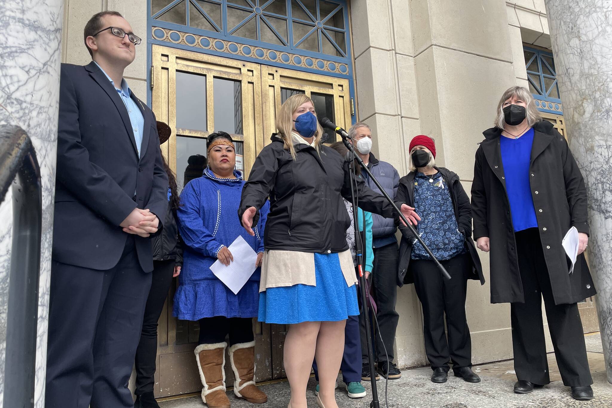 Rep. Geran Tarr, D-Anchorage, center, speaks as state lawmakers and children’s welfare advocates attend a Blue Shirt Day event at the Alaska State Capitol, honoring the beginning of Child Abuse Prevention Month on April 1, 2022. (Michael S. Lockett / Juneau Empire)