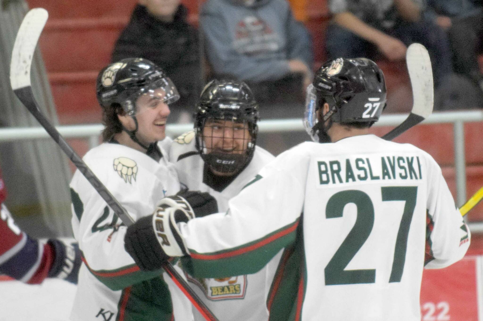 Kenai River Brown Bears forward Nick Ostbloom (center) celebrates his goal with Ryan Finch and Barak Braslavski on Saturday, April 2, 2022, at the Soldotna Regional Sports Complex in Soldotna, Alaska. (Photo by Jeff Helminiak/Peninsula Clarion)