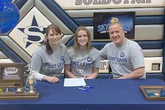 Soldotna senior Rhys Cannava, with parents Joe and Dana Cannava, signs her National Letter of Intent on Tuesday, April 5, 2022, at Soldotna High School in Soldotna, Alaska. (Photo provided)