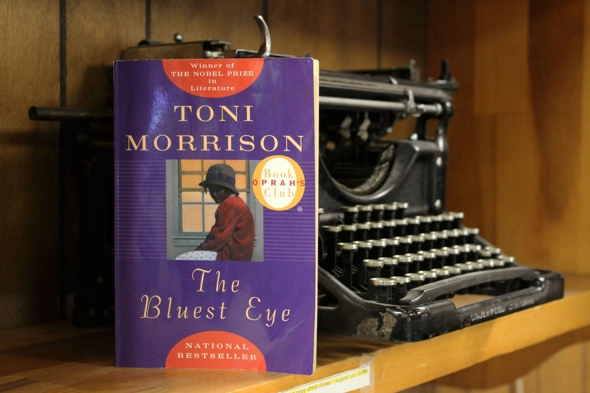 A copy of Toni Morrison’s “The Bluest Eye” rests against a typewriter on Wednesday, April 6, 2022, in Kenai, Alaska. (Ashlyn O’Hara/Peninsula Clarion)