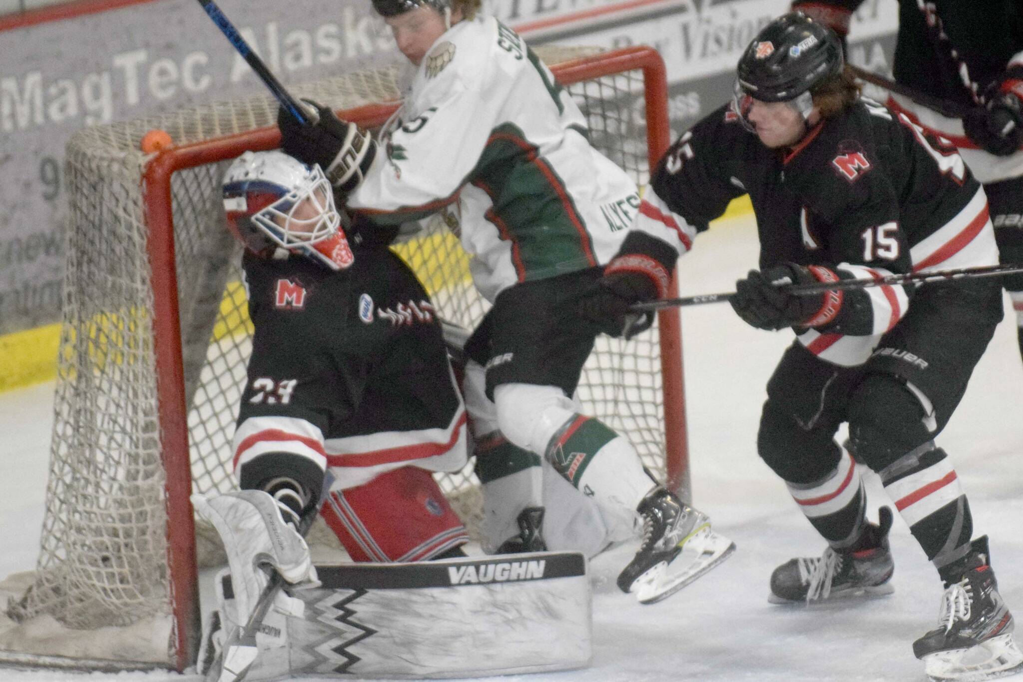 Kenai River Brown Bears forward Nick Stevens runs into Minnesota Magicians goalie Josh Langford on Saturday, April 9, 2022, at the Soldotna Regional Sports Complex in Soldotna, Alaska. (Photo by Jeff Helminiak/Peninsula Clarion)