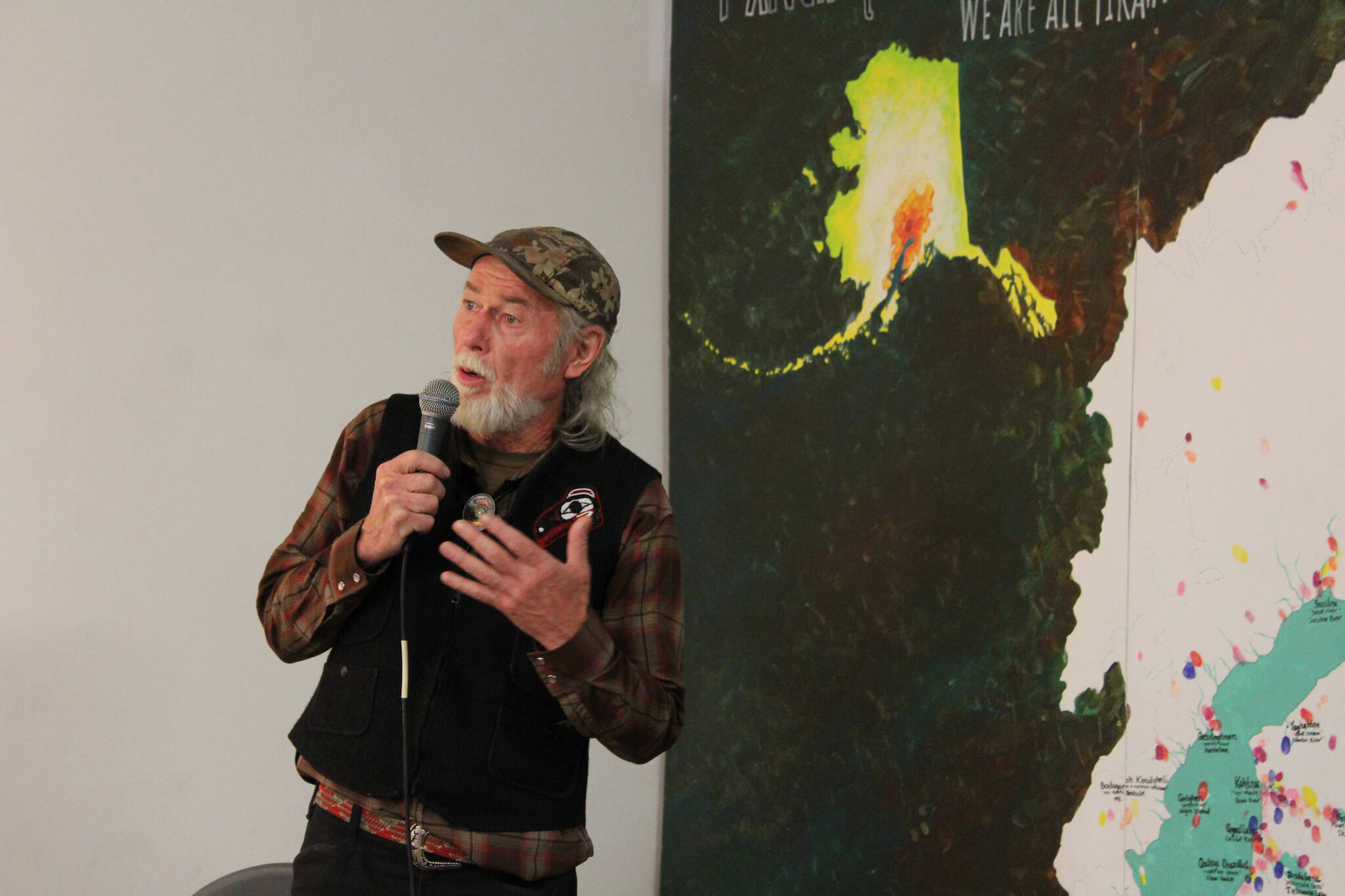 Steve M. Schoonmaker recites poetry as part of the opening of his show “Symbiotic Symphony: Alders and Salmon” at Cook Inletkeeper’s Community Action Studio on Friday, April 22, 2022, in Soldotna, Alaska. (Ashlyn O’Hara/Peninsula Clarion)