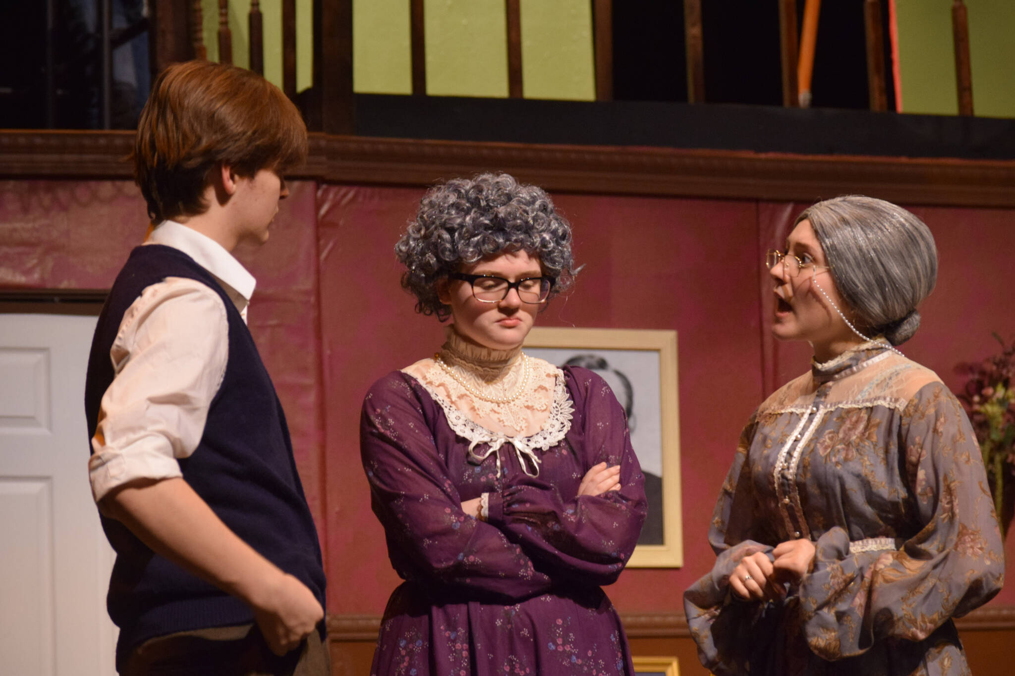 Left to right: Darek Hatten, Aidan Bon and Sophia Micciche rehearse “Arsenic and Old Lace” at Soldotna High School on Tuesday, April 26, 2022. (Camille Botello/Peninsula Clarion)