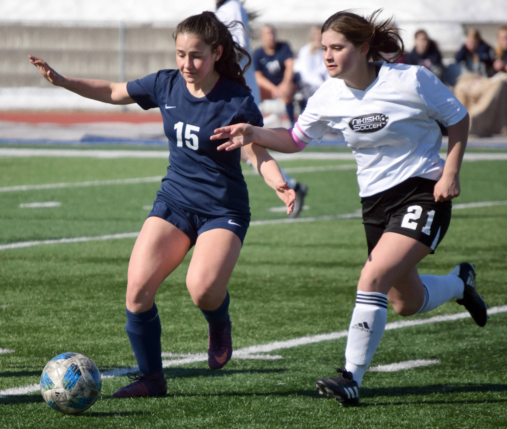 Soldotna’s Katharine Bramante and Nikiski’s Mady Stichal battle for the ball Wednesday, April 27, 2022, at Justin Maile Field at Soldotna High School in Soldotna, Alaska. (Photo by Jeff Helminiak/Peninsula Clarion)