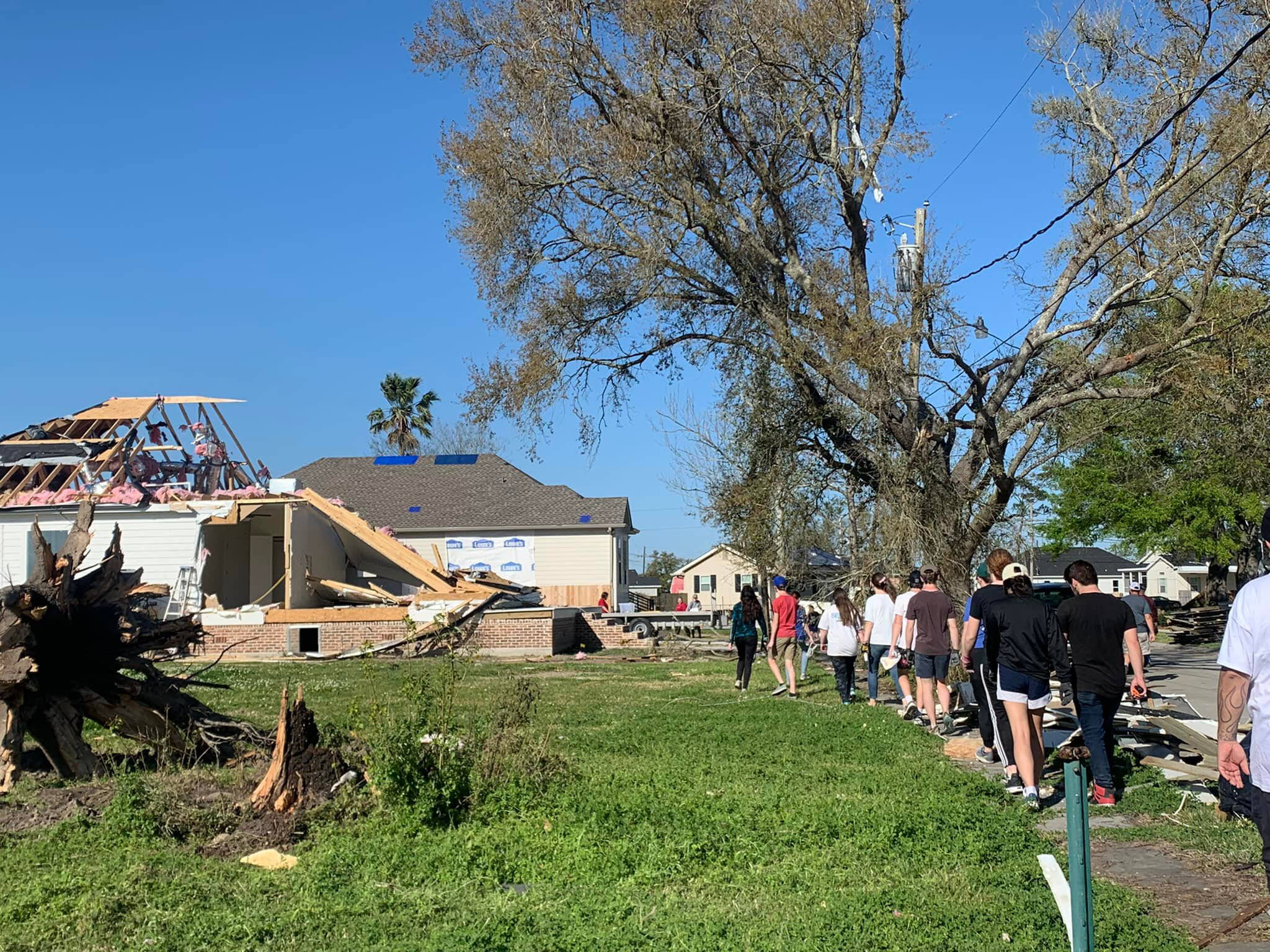 Cook Inlet Academy students clear debris during their mission trip in New Orleans, La., on Friday, March 25, 2022. (Photo courtesy Ginni Hagedorn)