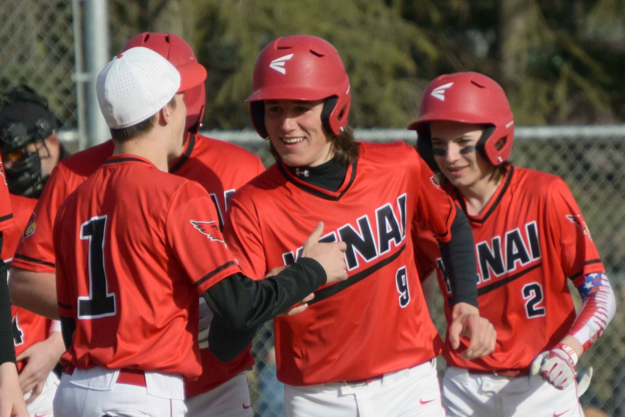 Kenai Central's Simon Grenier (9) celebrates his grand slam against Soldotna with teammates at the Soldotna Little League fields Wednesday, May 4, 2022, in Soldotna, Alaska. (Photo by Jeff Helminiak/Peninsula Clarion)