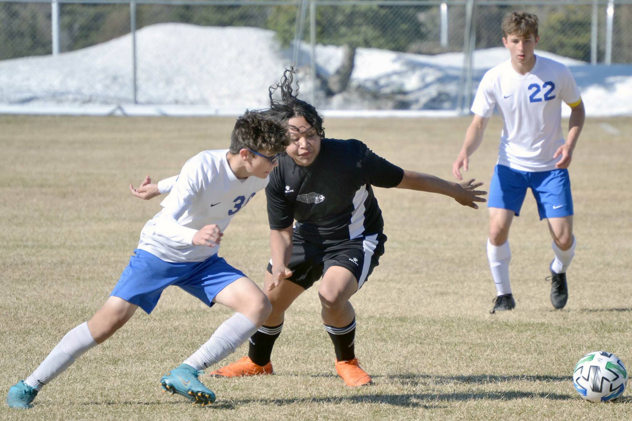 Soldotna's Simon Willets and Nikiski's Jakeup Martin battle for the ball Monday, May 9, 2022, at Nikiski High School in Nikiski, Alaska. (Photo by Jeff Helminiak/Peninsula Clarion)