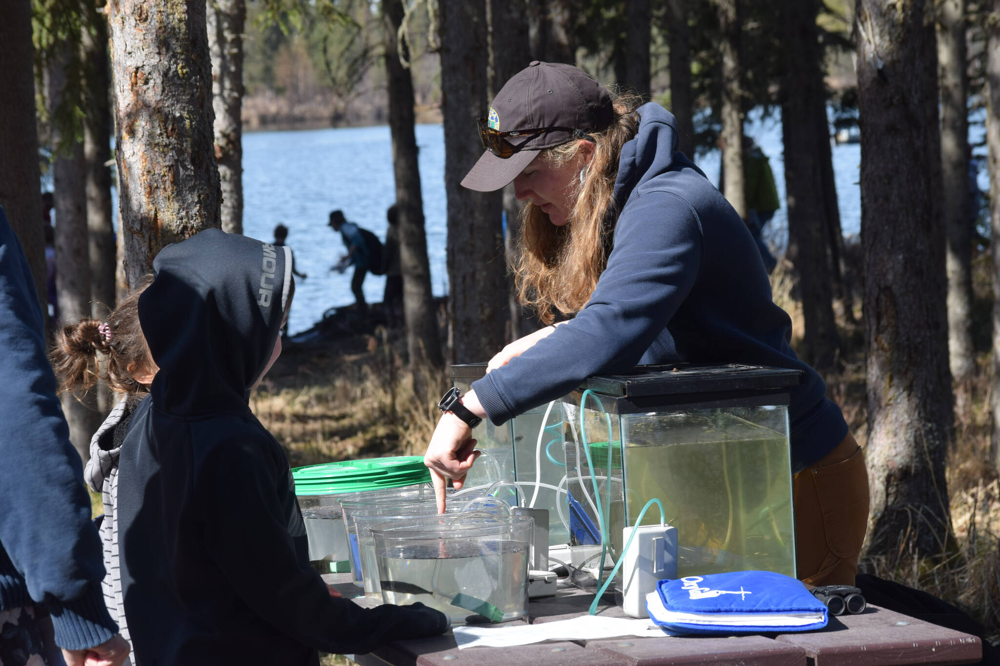 Kaitlynn Cafferty, a habitat biologist with the Alaska Department of Fish and Game, teaches kids about fish species at the 21st annual Kenai Peninsula Salmon Celebration in Kasilof on Wednesday, May 11, 2022. (Camille Botello/Peninsula Clarion)