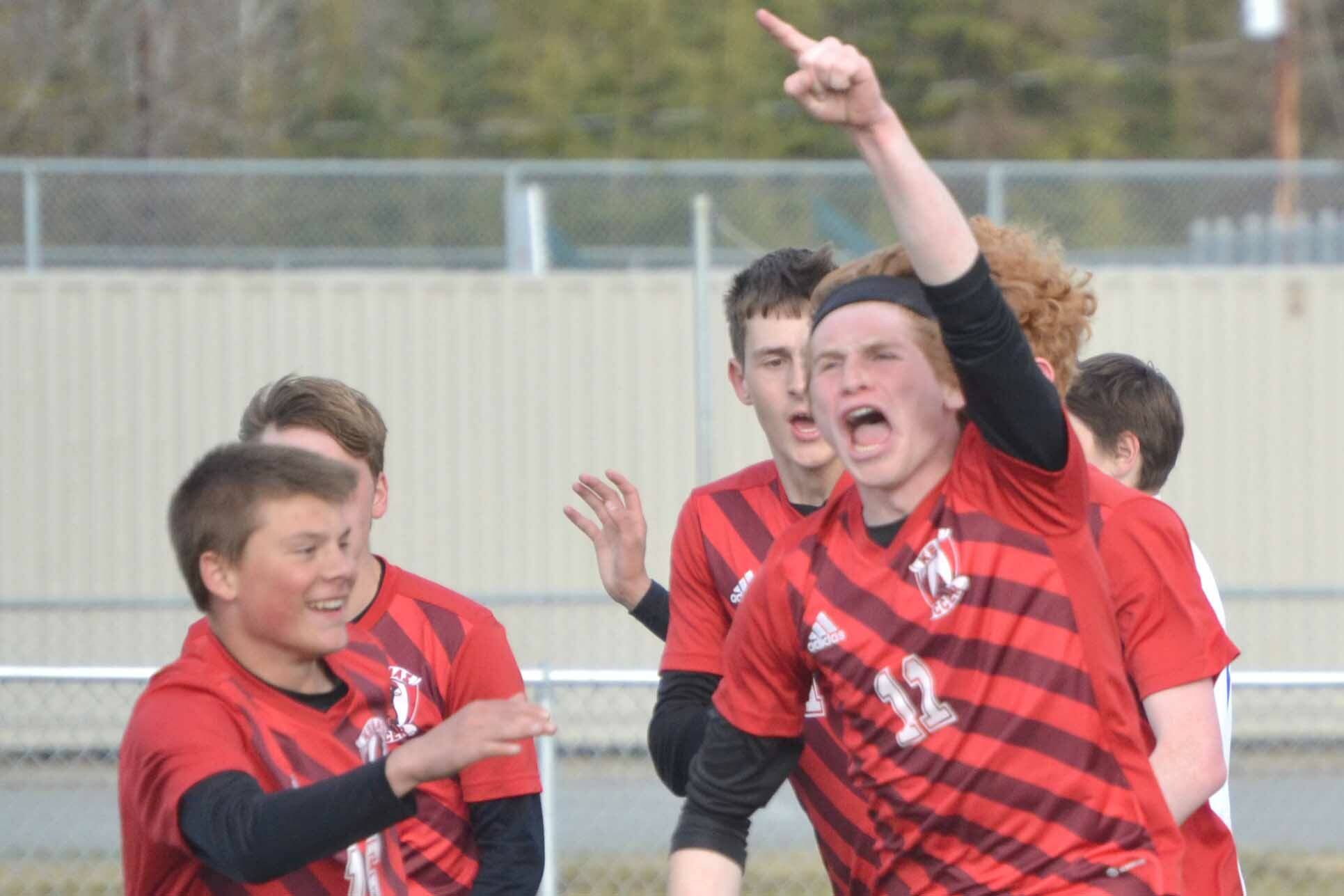 Kenai Central's Wade James celebrates his first-half goal against Soldotna on Friday, May 13, 2022, at Ed Hollier Field at Kenai Central High School in Kenai, Alaska. (Photo by Jeff Helminiak/Peninsula Clarion)