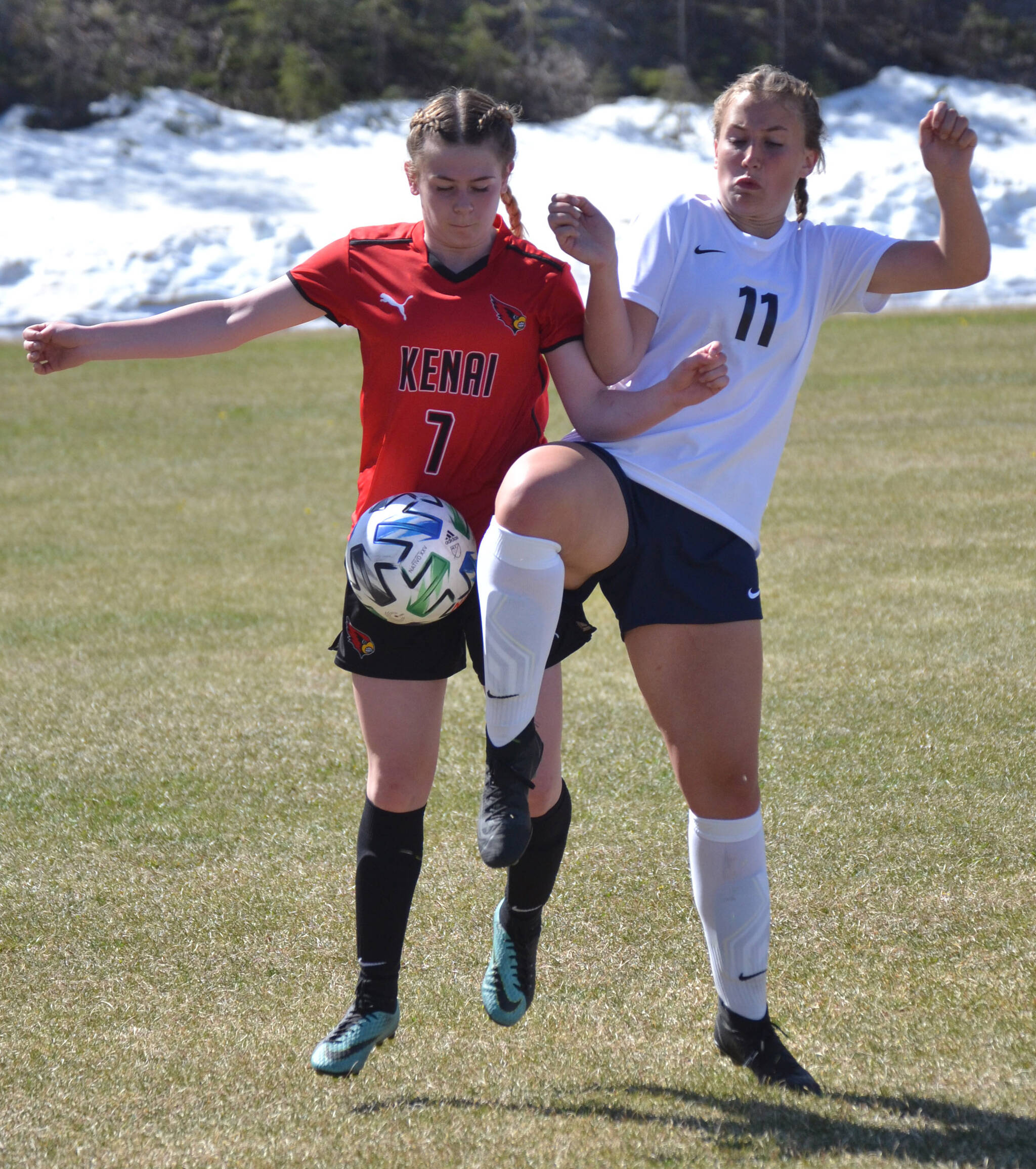 Kenai Central’s Tait Cooper and Soldotna’s Sadie Lane battle for the ball Friday, May 20, 2022, at the Peninsula Conference soccer tournament at Nikiski High School in Nikiski, Alaska. (Photo by Jeff Helminiak/Peninsula Clarion)