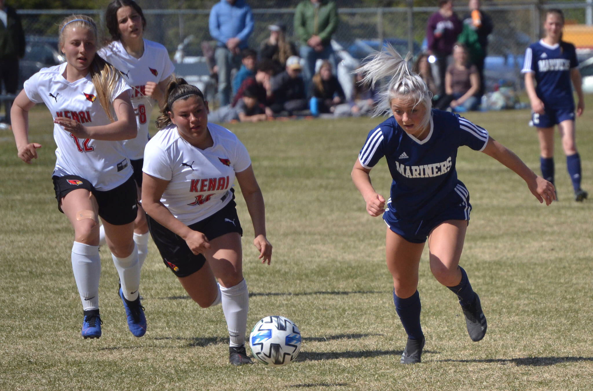 Homer’s Sela Weisser attacks Kenai Central’s Kate Wisnewski and Valerie Villegas in the Peninsula Conference championship game Saturday, May 21, 2022, at Nikiski High School in Nikiski, Alaska. (Photo by Jeff Helminiak/Peninsula Clarion)