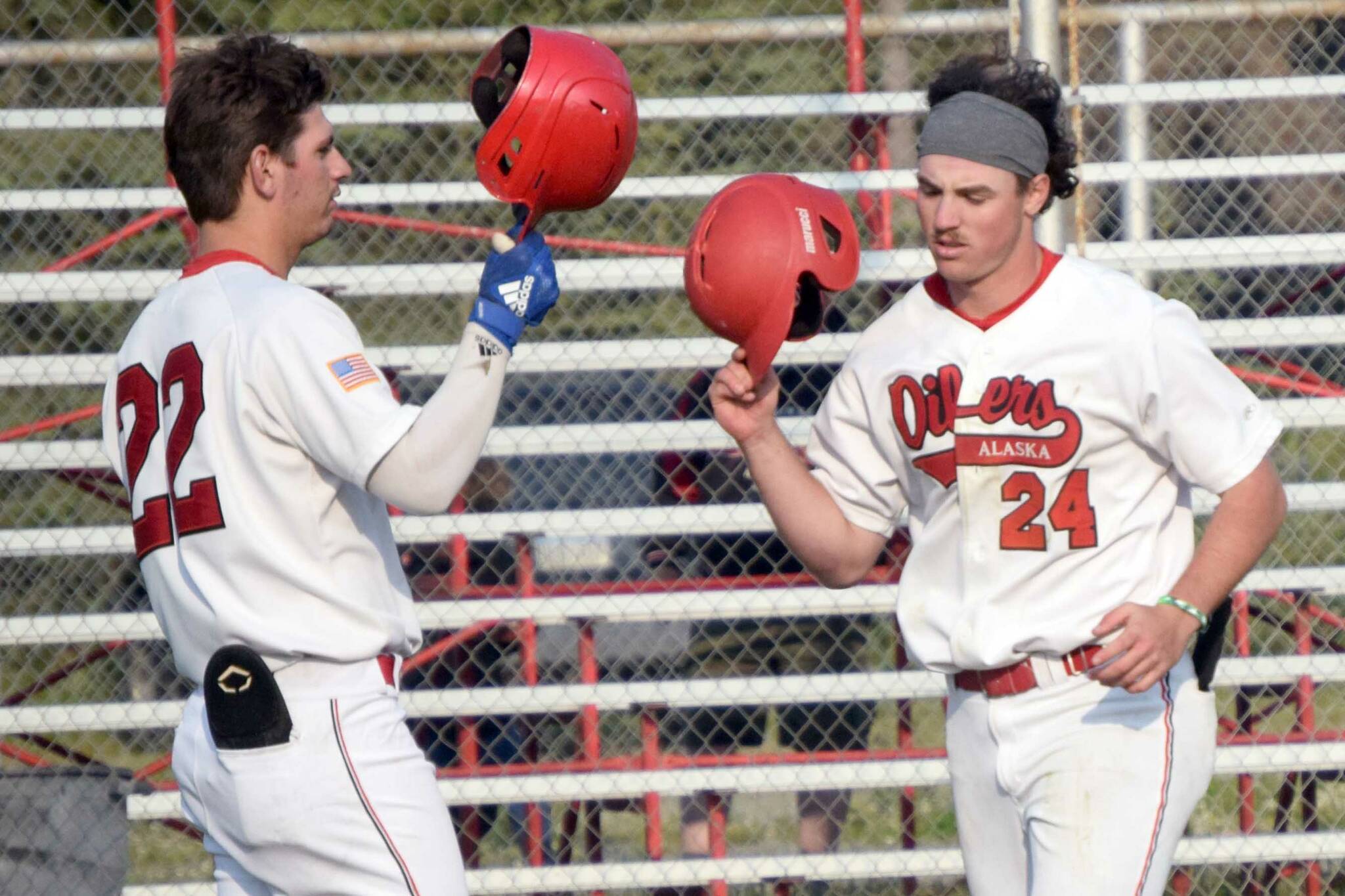 Oilers' Noah Hennings (24) celebrates his home run against the Anchorage Glacier Pilots with Dalton Bowling on Friday, June 24, 2022, at Coral Seymour Memorial Park in Kenai, Alaska. (Photo by Jeff Helminiak/Peninsula Clarion)