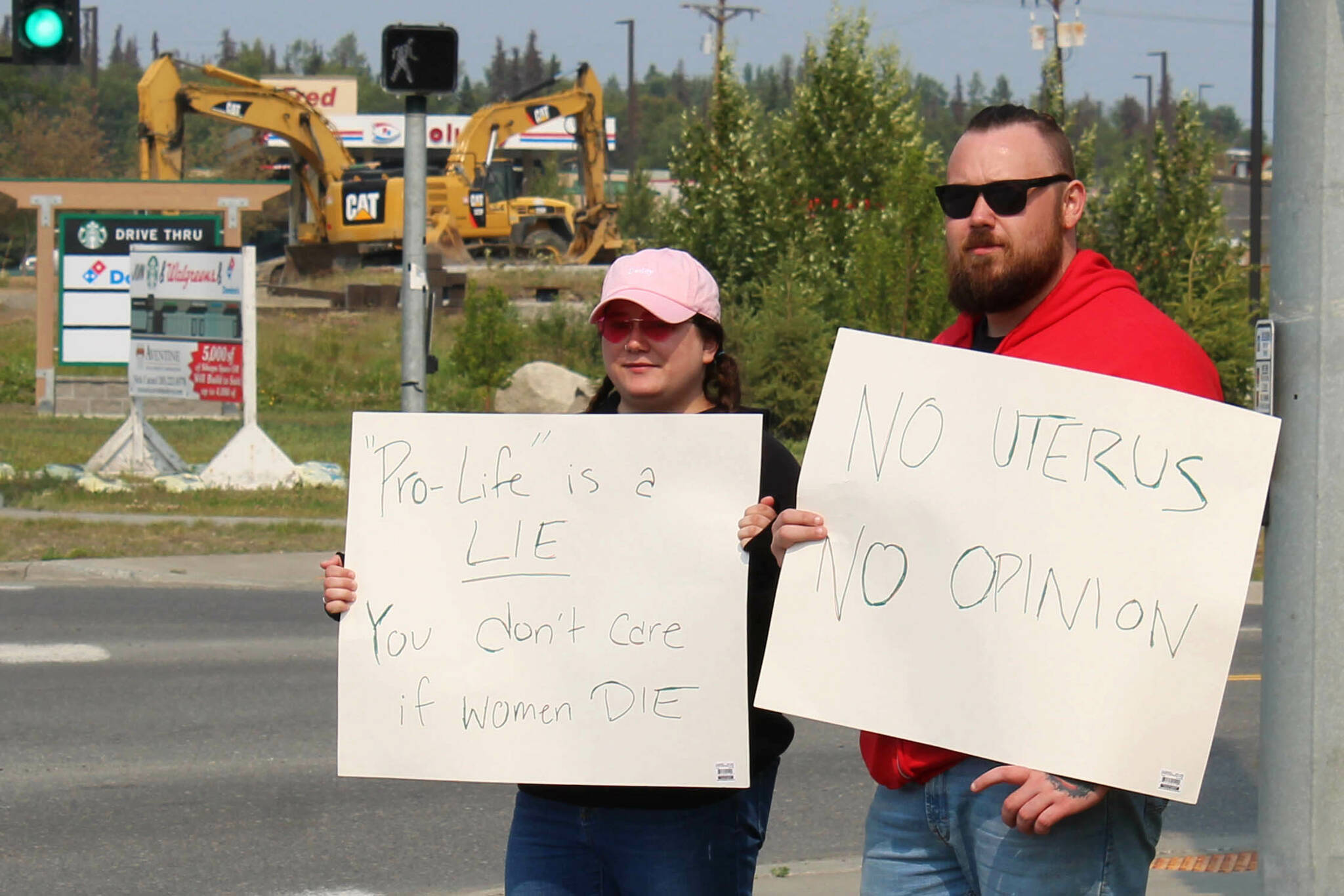 Megan Mitchell, left, and Nick McCoy protest the U.S. Supreme Court’s decision overturning of Roe v. Wade at the intersection of the Kenai Spur and Sterling highways on Friday, June 24, 2022 in Soldotna, Alaska. (Ashlyn O’Hara/Peninsula Clarion)