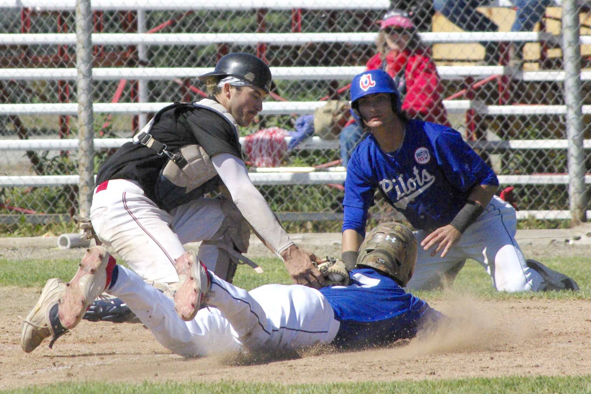 Oilers catcher Jerry Nix tags out Ali Camarillo of the Anchorage Glacier Pilots on Sunday, June 26, 2022, at Coral Seymour Memorial Park in Kenai, Alaska. (Photo by Jeff Helminiak/Peninsula Clarion)