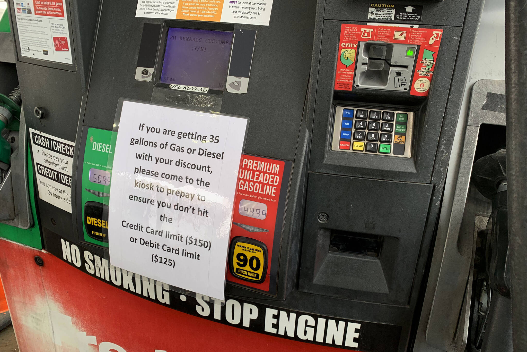 Signs warn Fred Meyer customers to prepay if they thing they may go over limits while pumping gas on Friday, March 11, 2022, in Soldotna, Alaska. (Ashlyn O’Hara/Peninsula Clarion)