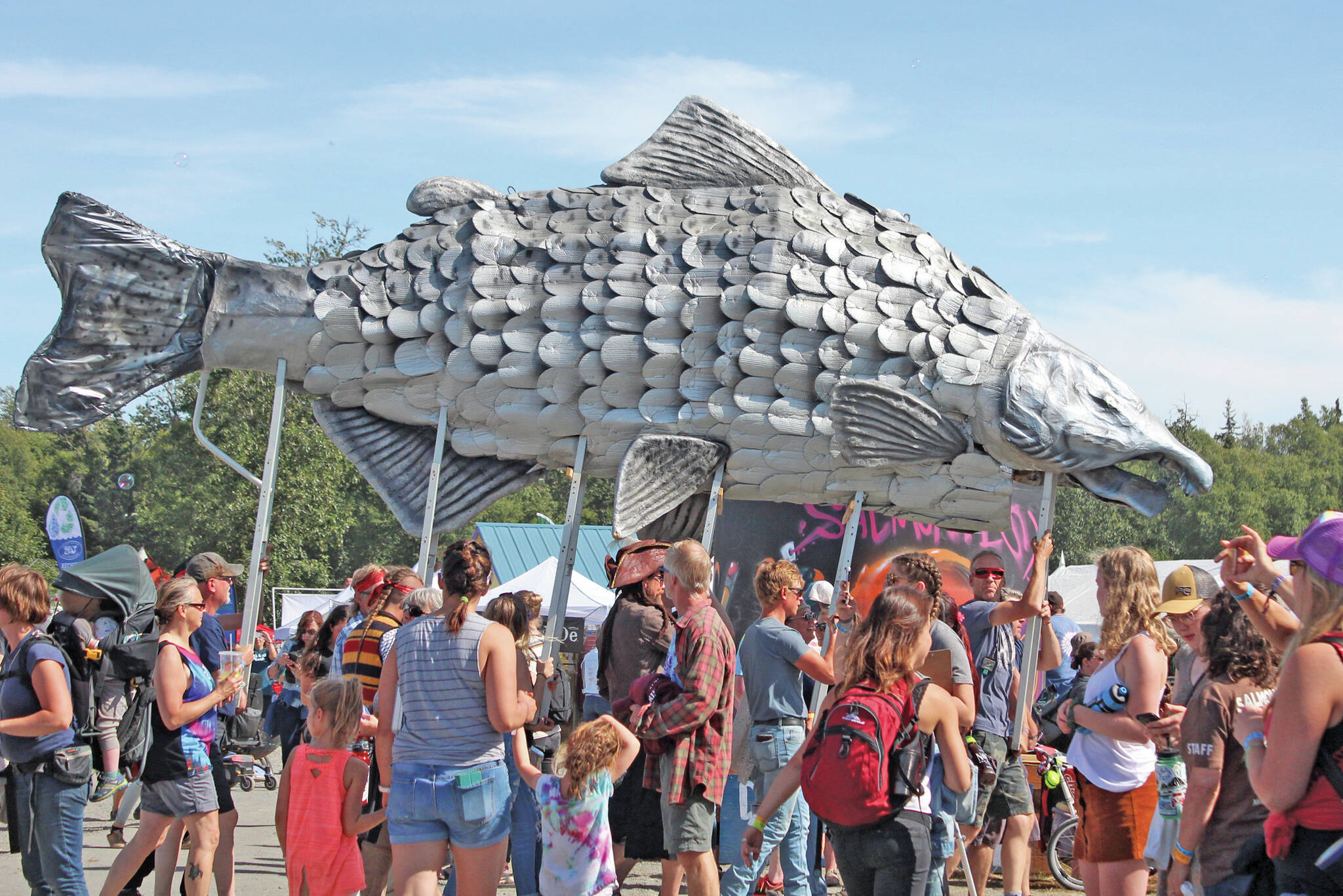 A giant silver salmon is paraded through Salmonfest on Saturday, Aug. 3, 2019, in Ninilchik, Alaska. (Photo by Megan Pacer/Homer News)