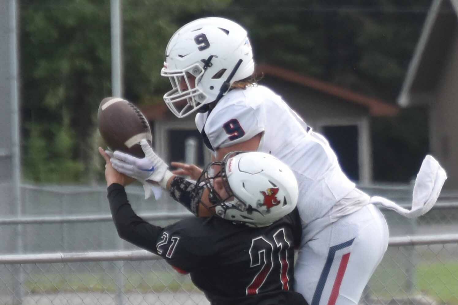 Kenai Central's Owen Whicker breaks up a pass intended for North Pole's Gabe Hollett on Saturday, Aug. 20, 2022, at Ed Hollier Field at Kenai Central High School in Kenai, Alaska. (Photo by Jeff Helminiak/Peninsula Clarion)