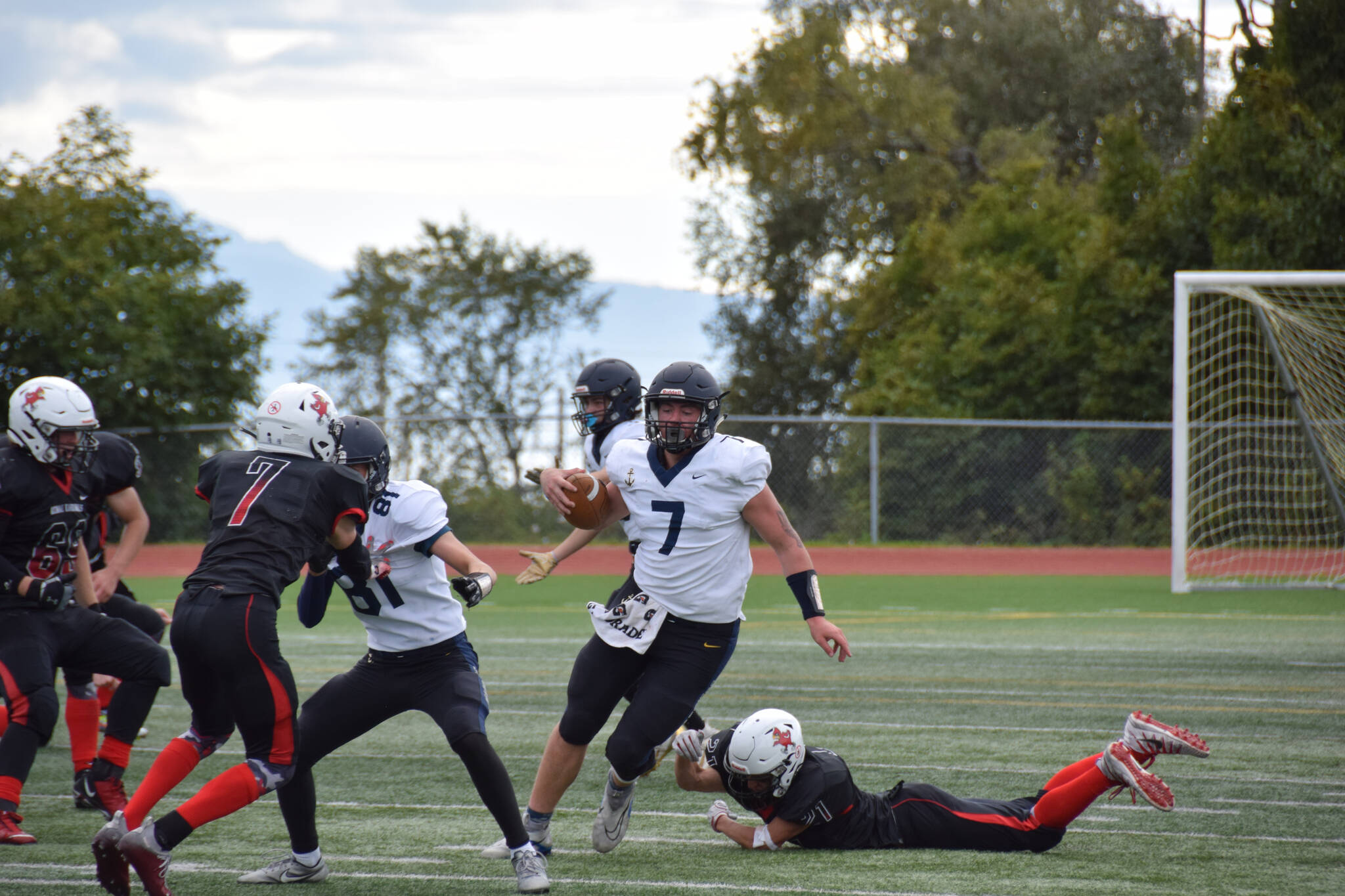 Homer’s Carter Tennison evades a diving tackle on Saturday, Sep. 3, at the Homer High School Field in Homer, Alaska. (Photo by Charlie Menke/ Homer News)