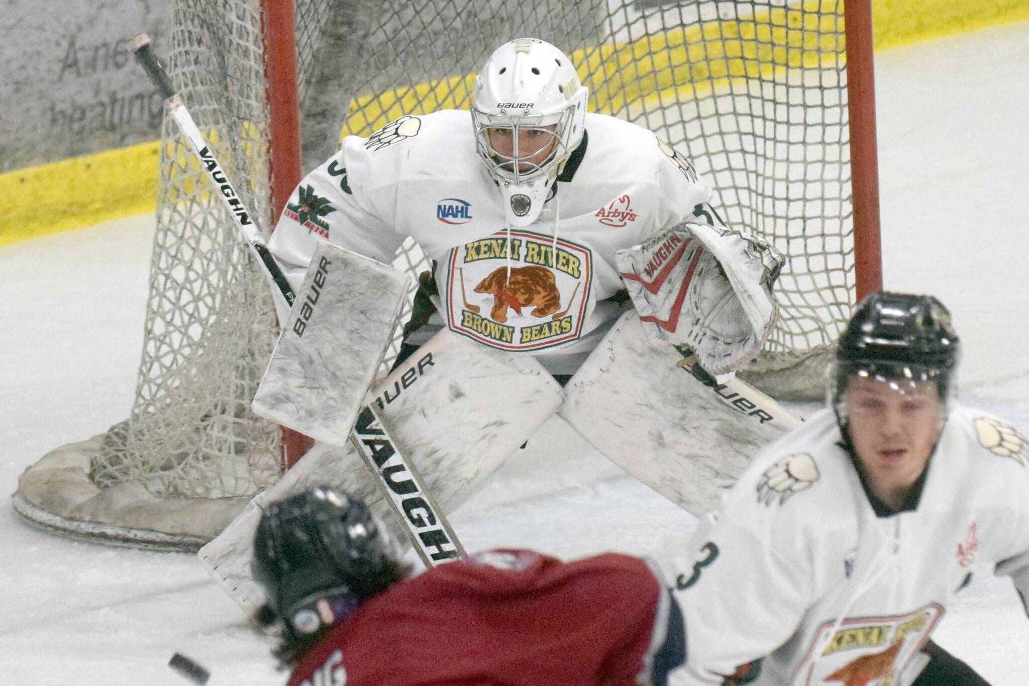 Kenai River Brown Bears goalie Bryant Marks saves a shot by Jack Ring of the Fairbanks Ice Dogs on Friday, March 12, 2022, at the Soldotna Regional Sports Complex in Soldotna, Alaska. (Photo by Jeff Helminiak/Peninsula Clarion)