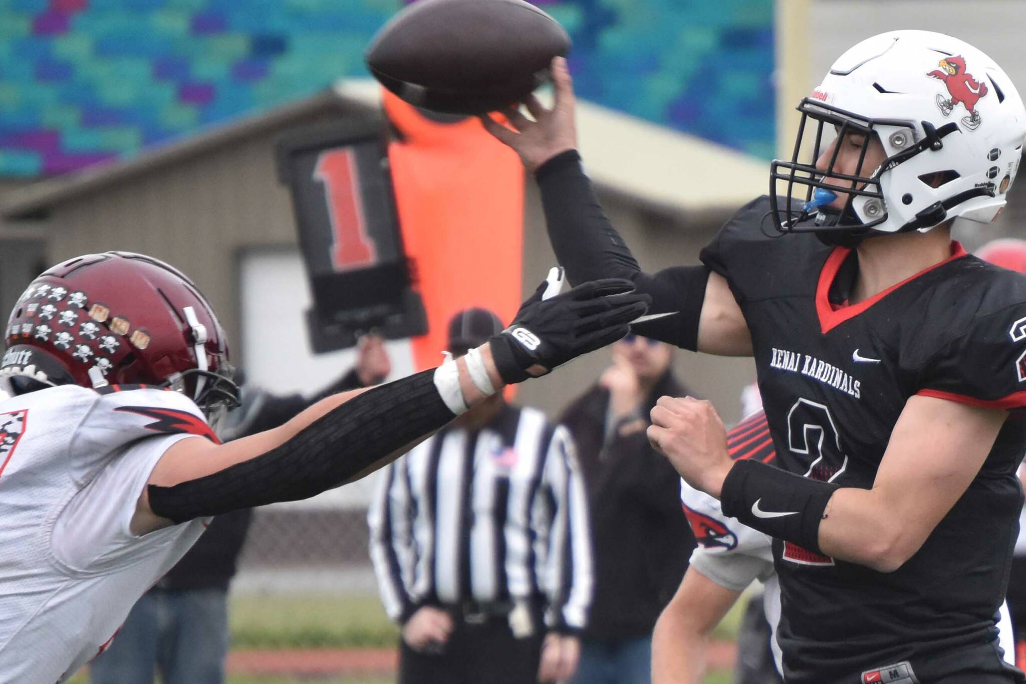 Kenai Central quarterback Bridger Beck throws under pressure from Houston's Keldin Nicoll on Saturday, Sept. 25, 2022, at Ed Hollier Field at Kenai Central High School in Kenai, Alaska. (Photo by Jeff Helminiak/Peninsula Clarion)