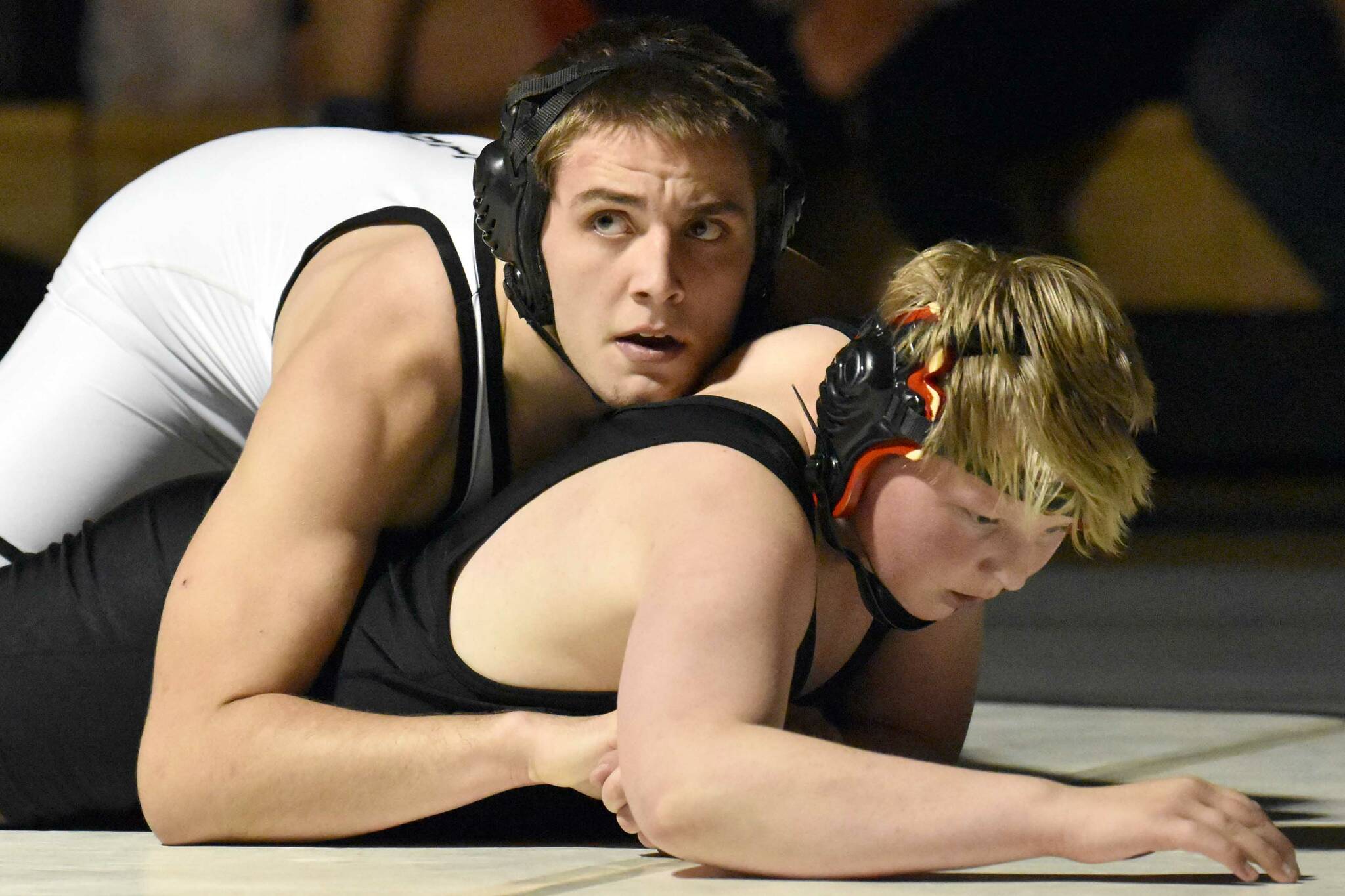 Nikiski's Tim Goodnight works to a pin over Kenai Central's Roman Dunham at 171 pounds Tuesday, Nov. 15, 2022, at Nikiski High School in Nikiski, Alaska. (Photo by Jeff Helminiak/Peninsula Clarion)