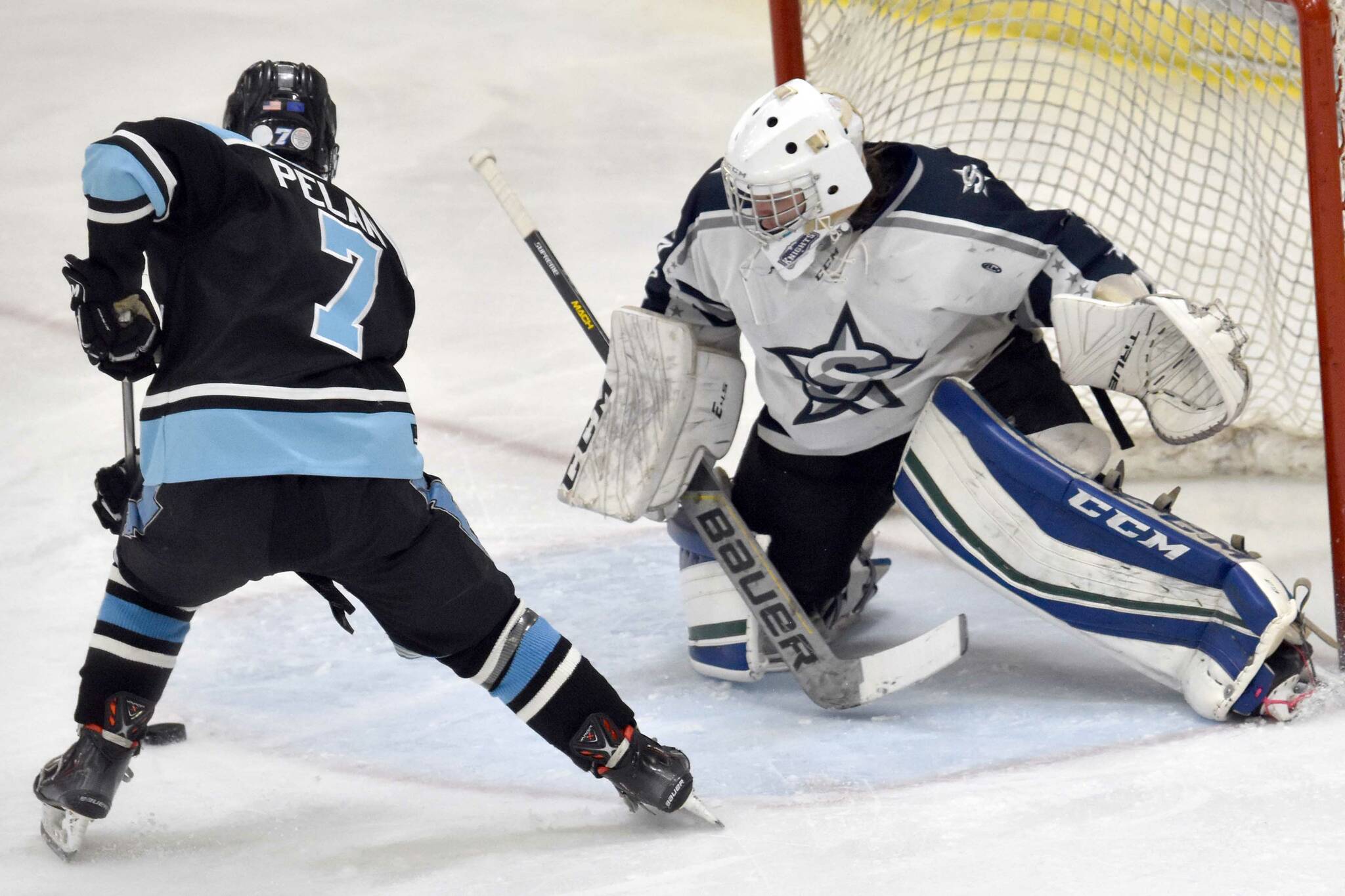 Soldotna goalie Jackson Purcell makes a save on Chugiak's Barrett Pelant on Friday, Nov. 18, 2022, at the Soldotna Regional Sports Complex in Soldotna, Alaska. (Photo by Jeff Helminiak/Peninsula Clarion)