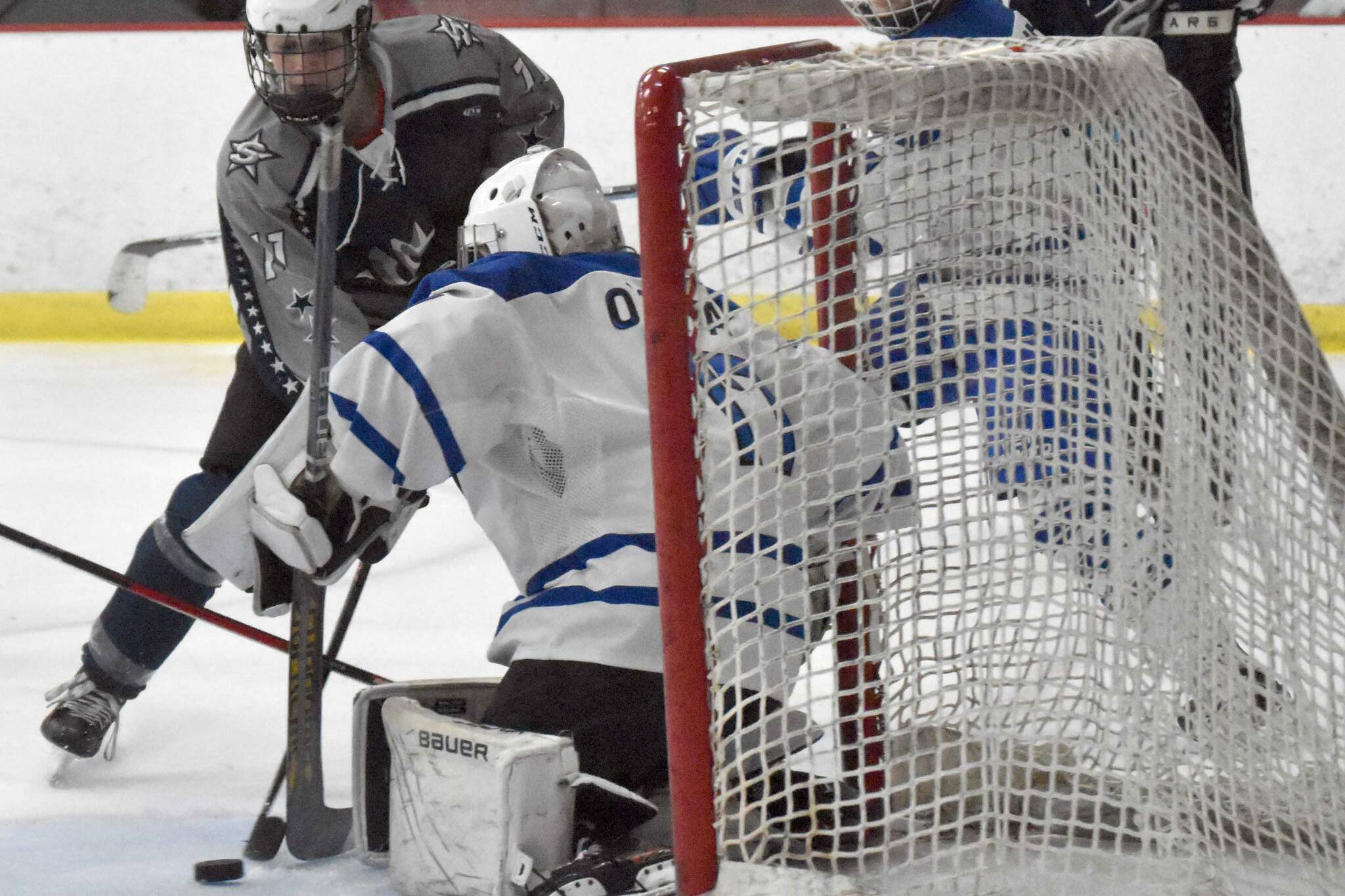 Soldotna's Boone Theiler pushes a shot wide on Palmer goalie Keagon O'Bryan on Thursday, Dec. 8, 2022, at the Soldotna Regional Sports Complex in Soldotna, Alaska. (Photo by Jeff Helminiak/Peninsula Clarion)