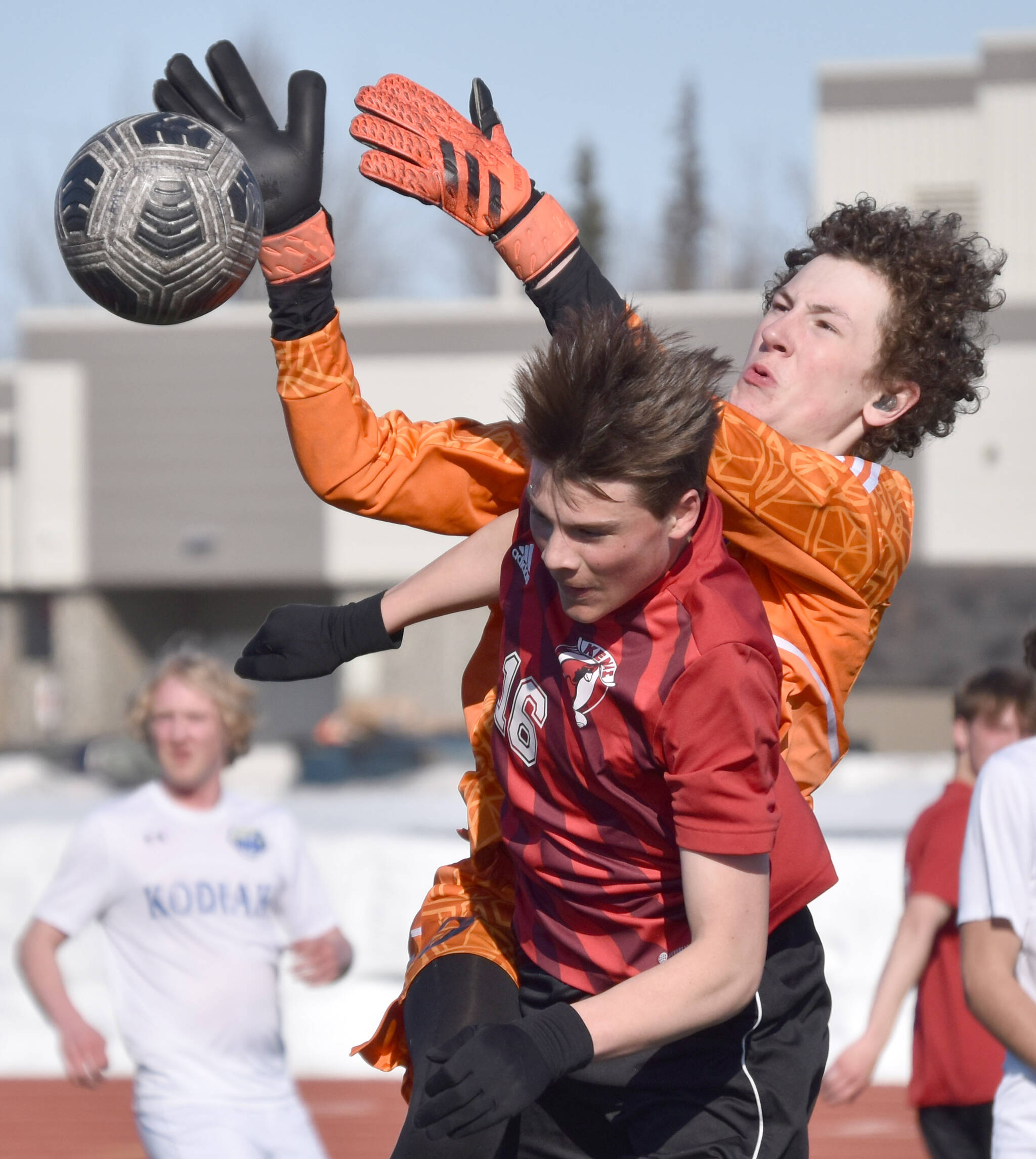 Kodiak goalie Dexter Smith and Kenai Central’s Sawyer Vann battle for the ball Thursday, April 20, 2023, at Ed Hollier Field at Kenai Central High School in Kenai, Alaska. (Photo by Jeff Helminiak/Peninsula Clarion)