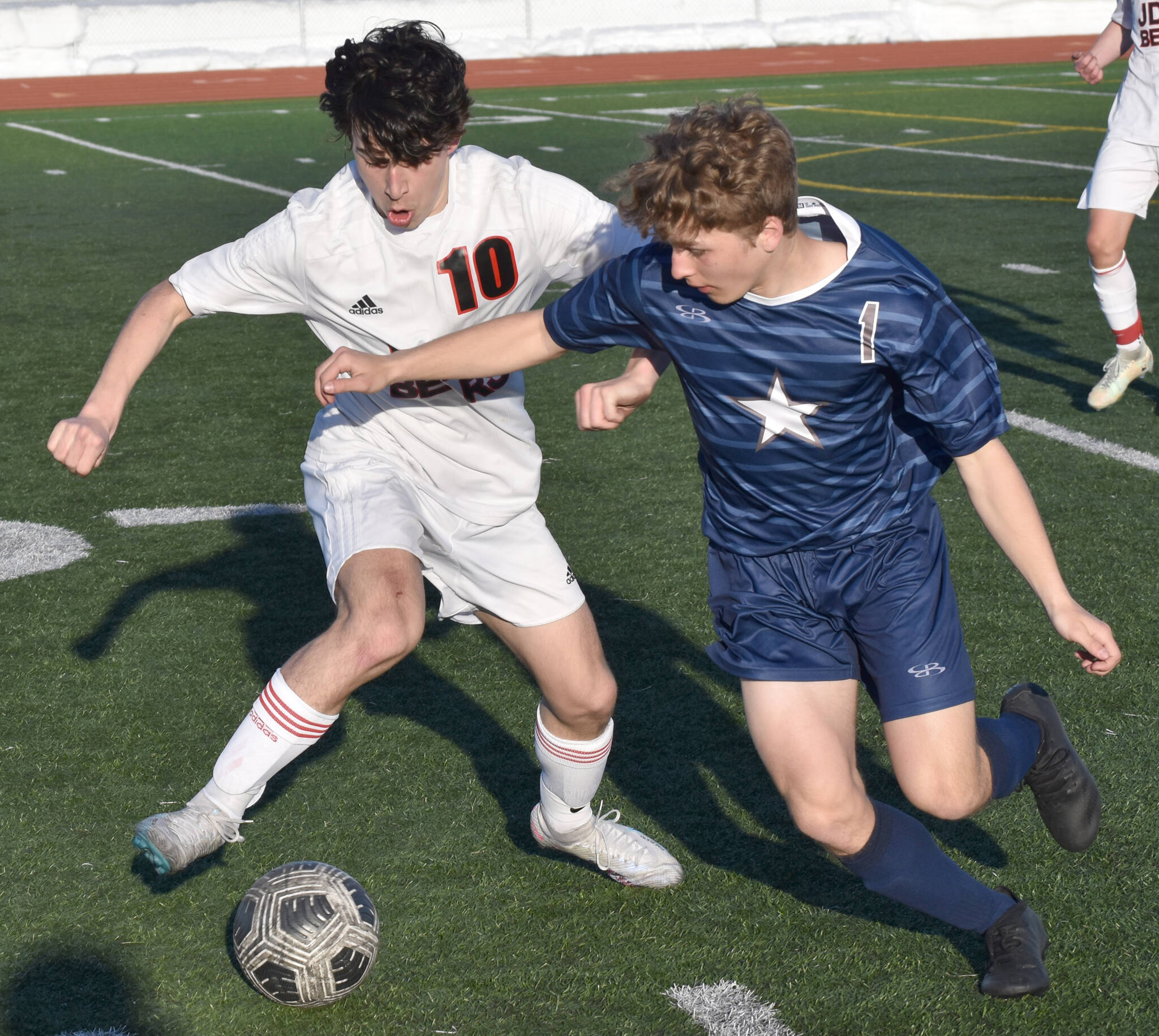 Kellen Chester of Juneau-Douglas: Yadaa.at Kale and Owen Buckbee of Soldotna battle for the ball Friday, April 21, 2023, at Ed Hollier Field at Kenai Central High School in Kenai, Alaska. (Photo by Jeff Helminiak/Peninsula Clarion)