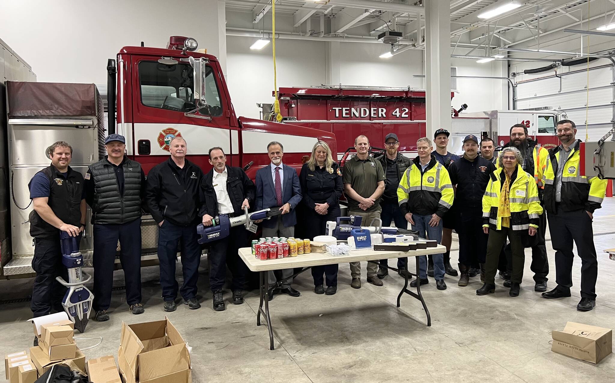 Kenai Peninsula Borough Mayor Peter Micciche (fifth from left) celebrates the receipt of extrication equipment alongside staff from Kenai Peninsula fire departments and the Girdwood Fire Department during a press event at the Girdwood Fire Department on Tuesday, April 25, 2023, in Girdwood, Alaska. (Photo courtesy Kenai Peninsula Borough Mayor’s Office)