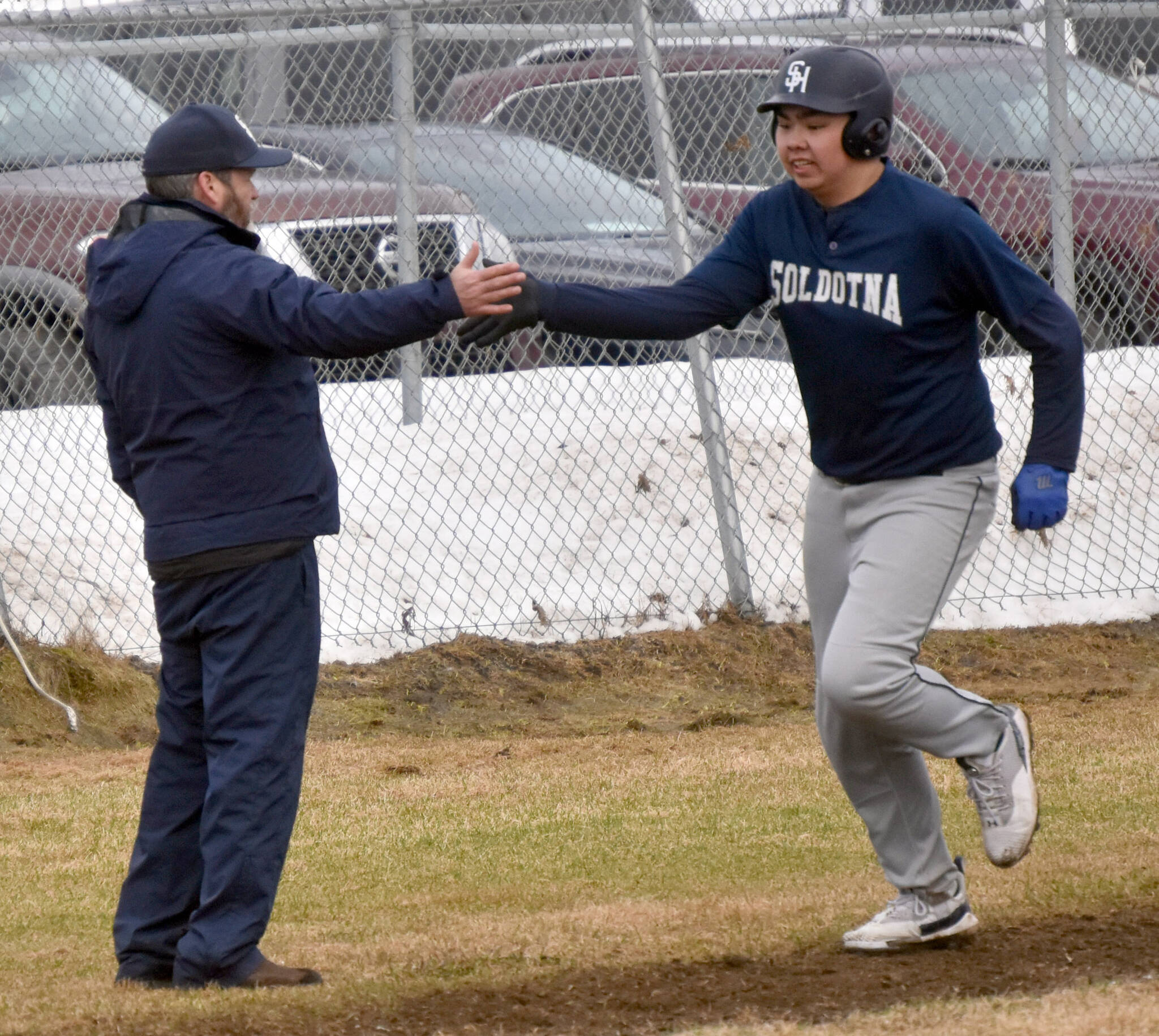 Soldotna head coach Ken Gibson congratulates Sage Cruz on his home run Tuesday, May 2, 2023, at the Kenai Little League Fields in Kenai, Alaska. (Photo by Jeff Helminiak/Peninsula Clarion)