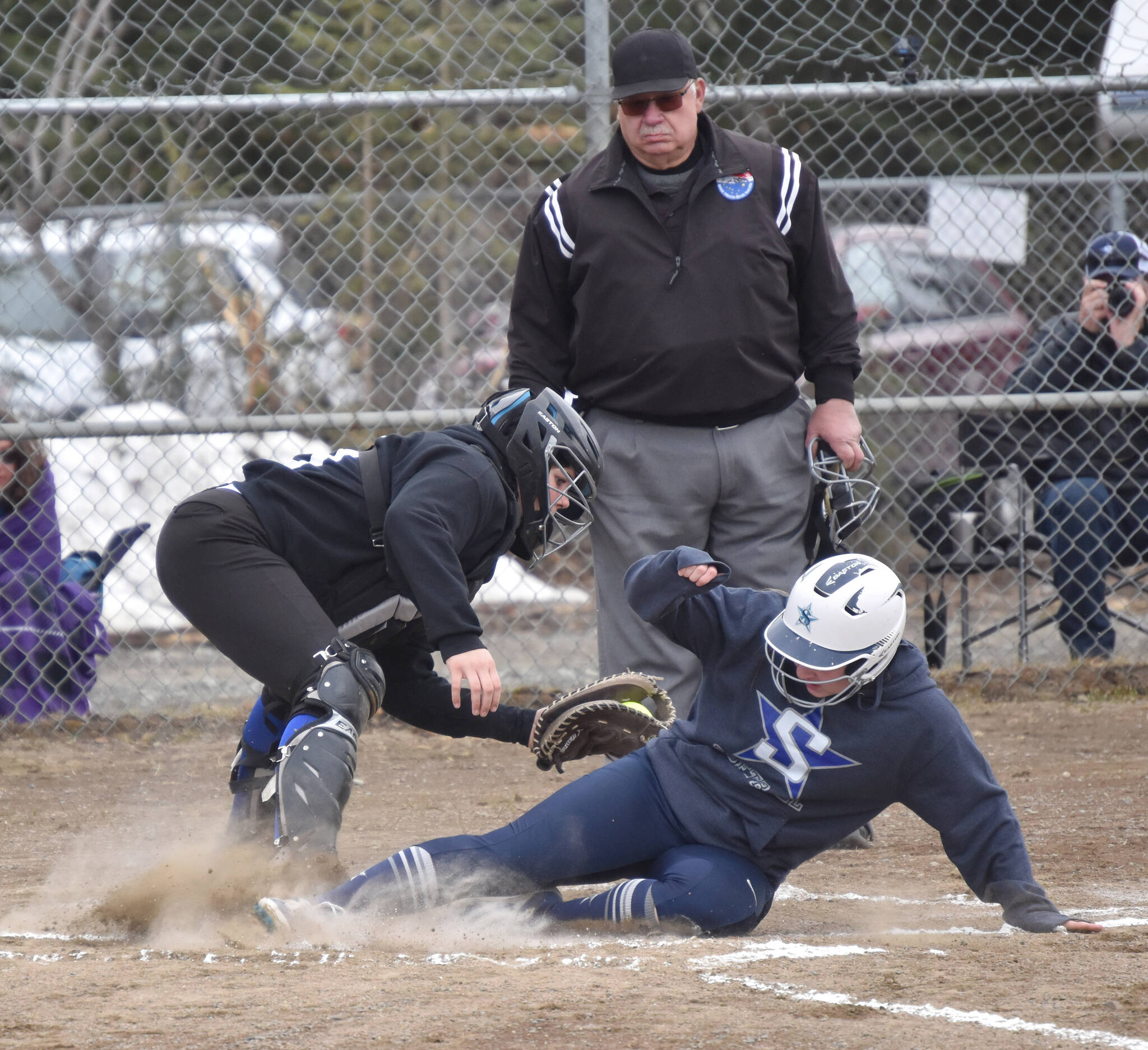 Soldotna’s Kiara “KiKi” Forkner slides under the tag of Kodiak catcher Hailee Henslee on Saturday, May 6, 2023, at the Soldotna Little League fields in Soldotna, Alaska. (Photo by Jeff Helminiak/Peninsula Clarion)