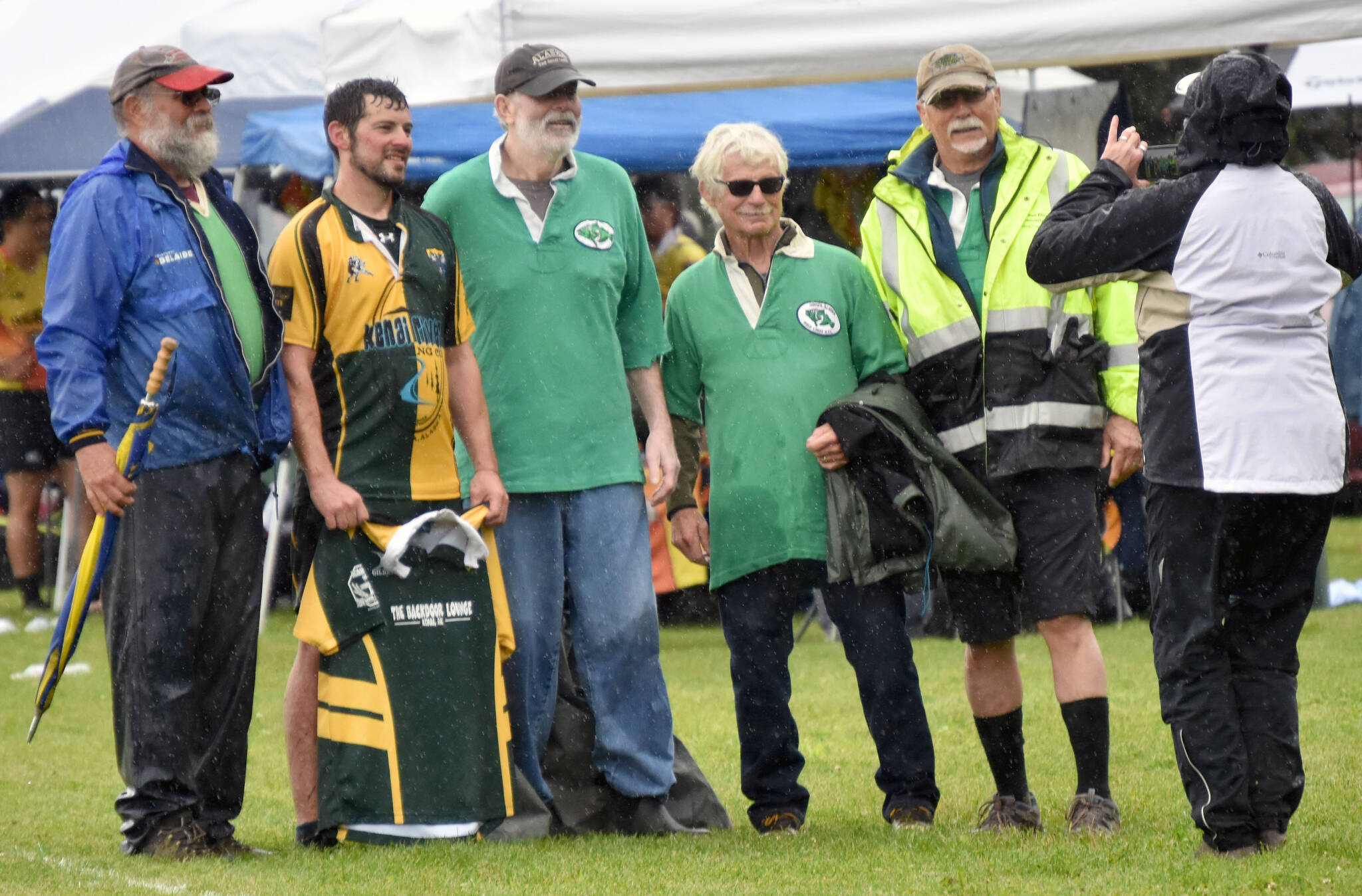 John Fitzpatrick, Dan Balmer, Chip Duggan, Tom Klinker and Wayne Aderhold pose at the Between the Tides Rugby Tourney at Millennium Square Field on Saturday, July 15, 2023. Fitzpatrick, Duggan, Klinker and Aderhold used to play for the Homer Irish Lords. Balmer is the president and coach for the Kenai Wolfpack. (Photo by Jeff Helminiak/Peninsula Clarion)