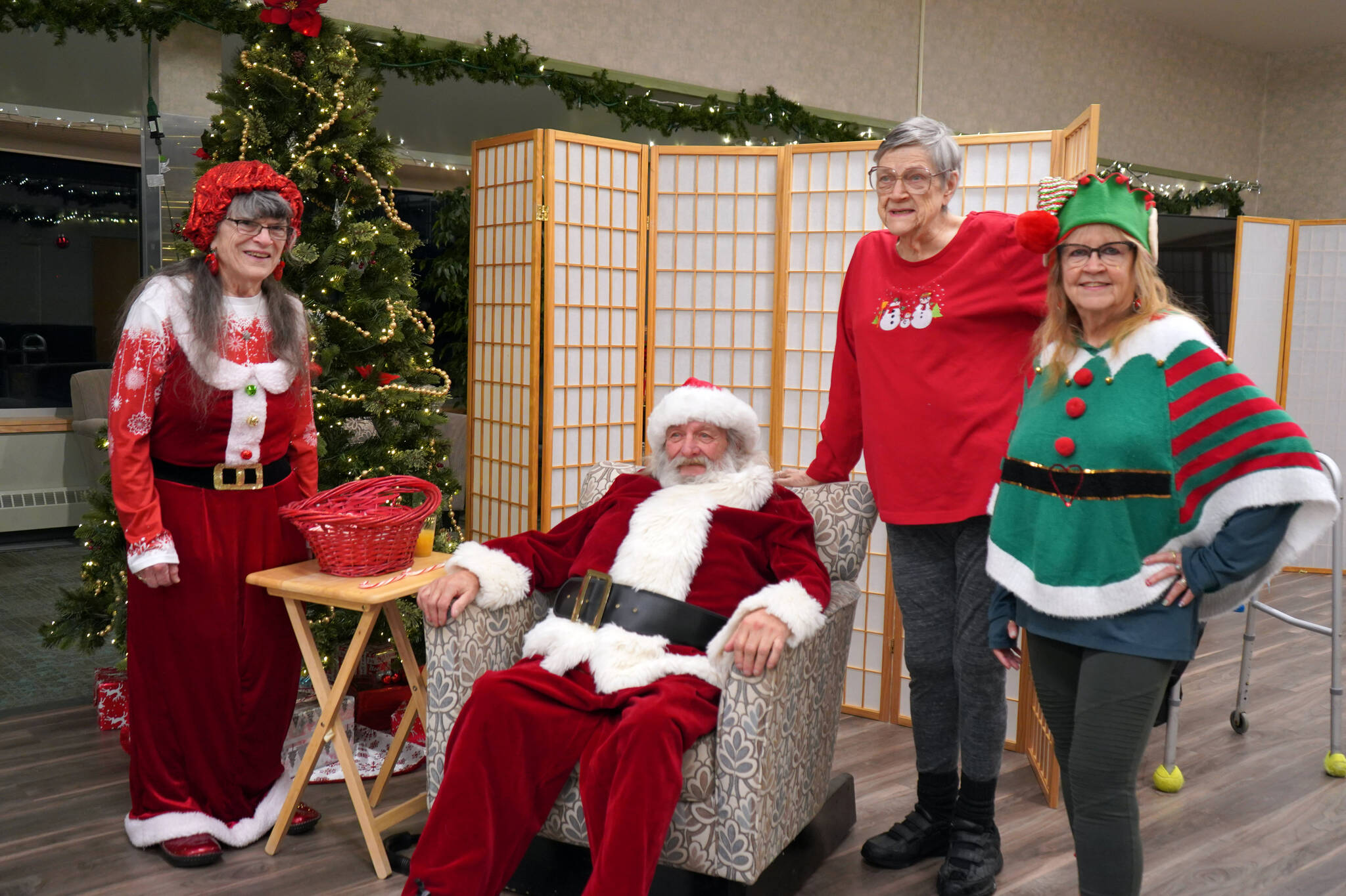 Santa and Mrs. Claus appear for photos during A Day with the Clauses festivities at the Kenai Senior Center in Kenai, Alaska, on Monday, Dec. 18, 2023. (Jake Dye/Peninsula Clarion)