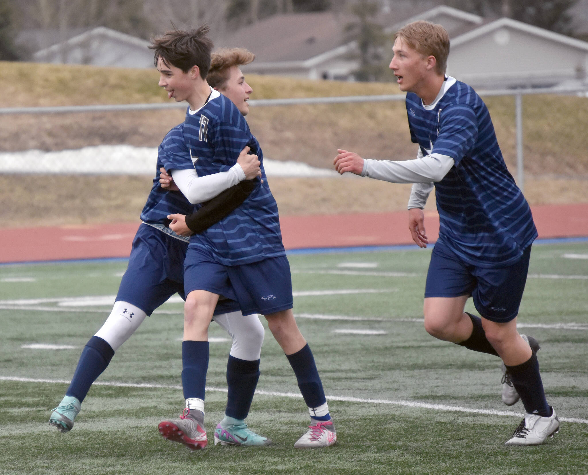 Soldotna’s Lane Hillyer (front) celebrates his goal against Ketchikan with teammates Thursday, May 2, 2024, at Soldotna High School in Soldotna, Alaska. (Photo by Jeff Helminiak/Peninsula Clarion)