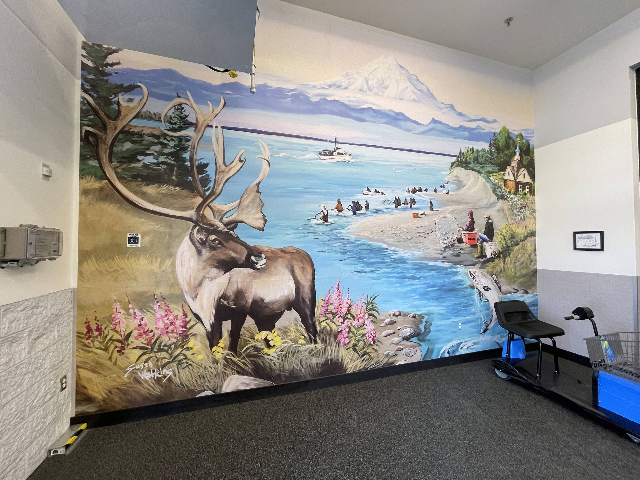 A mural depicting imagery and iconography of Kenai brightens the entryway of the Walmart in Kenai, Alaska, on Wednesday, May 15, 2024. (Jake Dye/Peninsula Clarion)