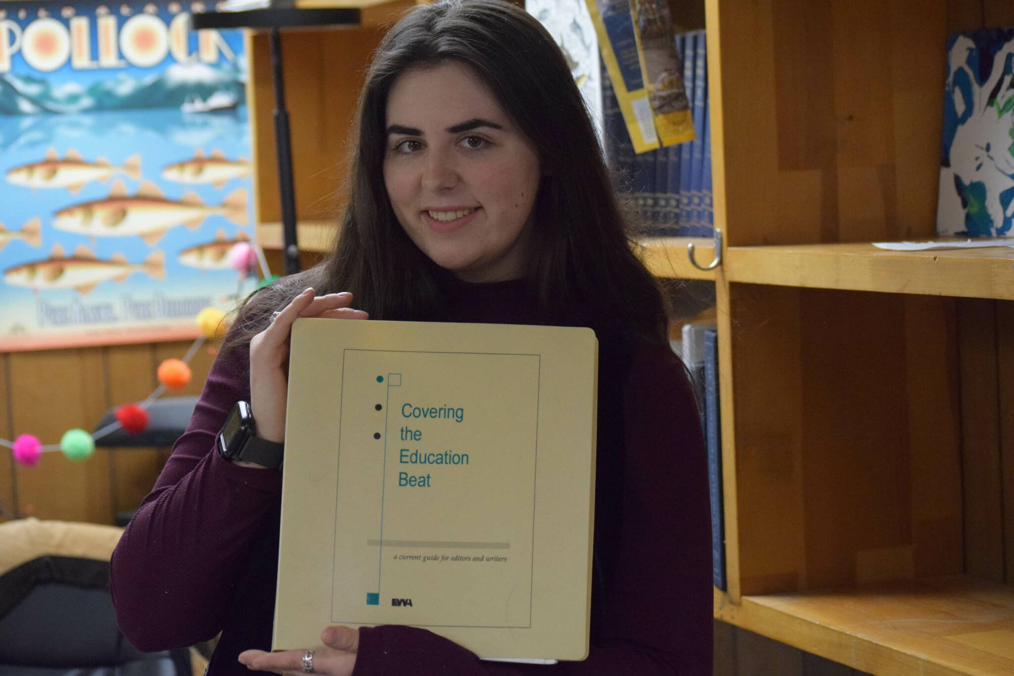 Me posing with a vintage guide to reporting on education. (Photo by Camille Botello)