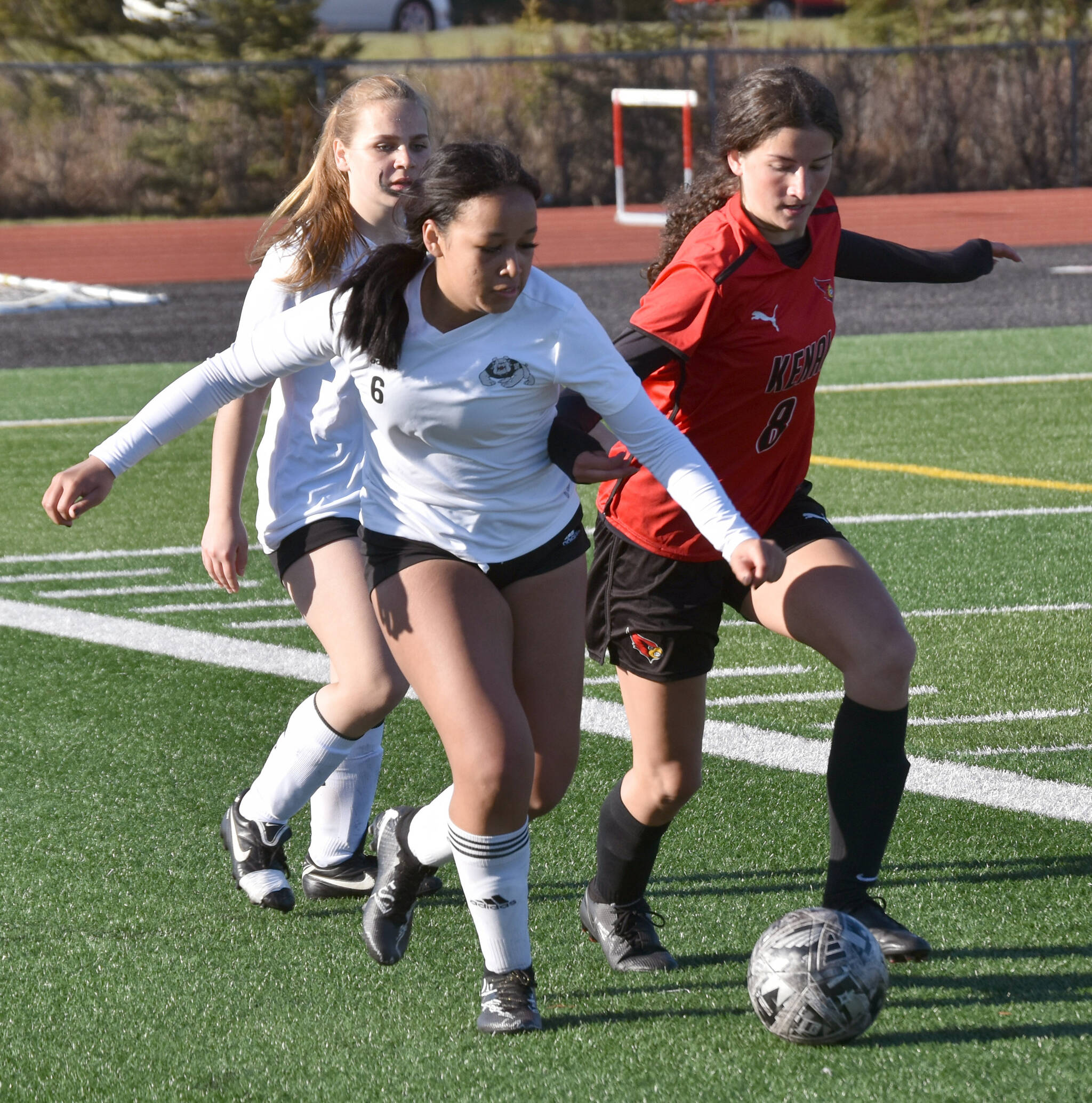 Nikiski’s Maddie Iyatunguk and Kenai Central’s Chloe Grimm battle for the ball Friday, May 17, 2024, at Kenai Central High School in Kenai, Alaska. (Photo by Jeff Helminiak/Peninsula Clarion)