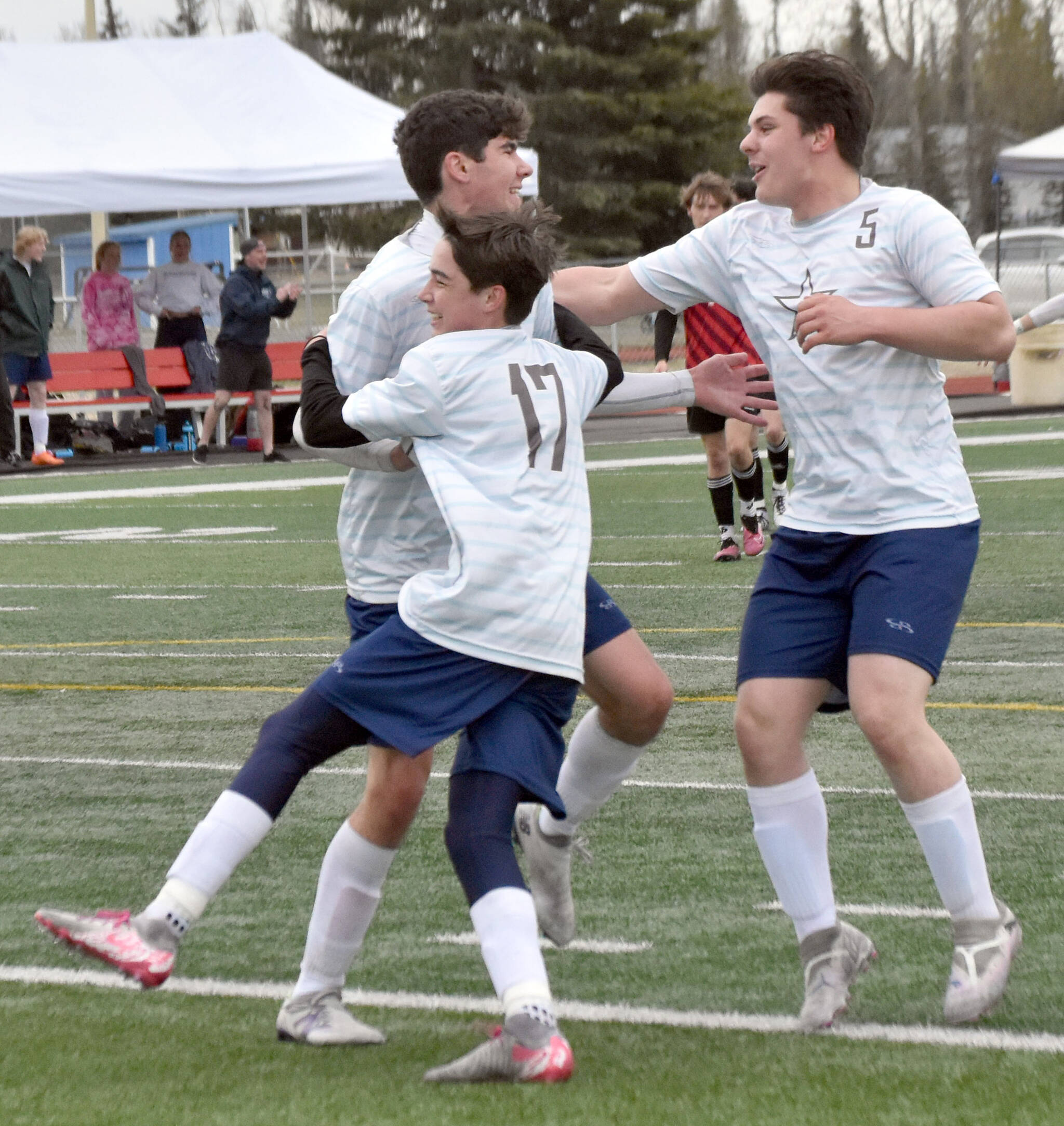Soldotna’s Andrew Arthur celebrates his goal with Lane Hillyer (17) and Gehret Medcoff (5) on Saturday, May 18, 2024, at the Peninsula Conference tournament at Kenai Central High School in Kenai, Alaska. (Photo by Jeff Helminiak/Peninsula Clarion)