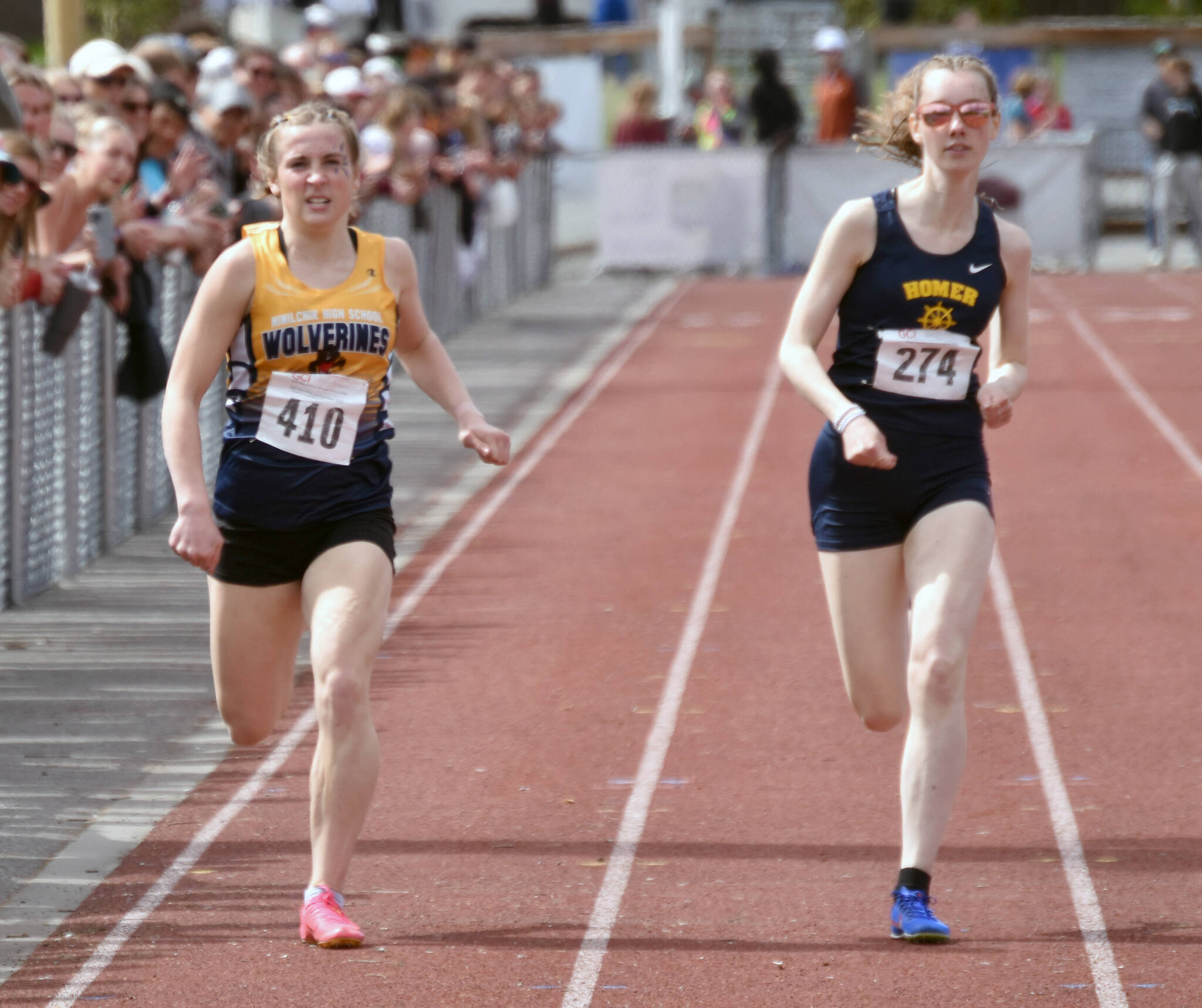 Ninilchik’s Adelyn McCorison finishes seventh and Homer’s Beatrix McDonough finishes sixth in the 400-meter dash at the Division II state track and field meet Saturday, May 25, 2024, at Dimond High School in Anchorage, Alaska. (Photo by Jeff Helminiak/Peninsula Clarion)