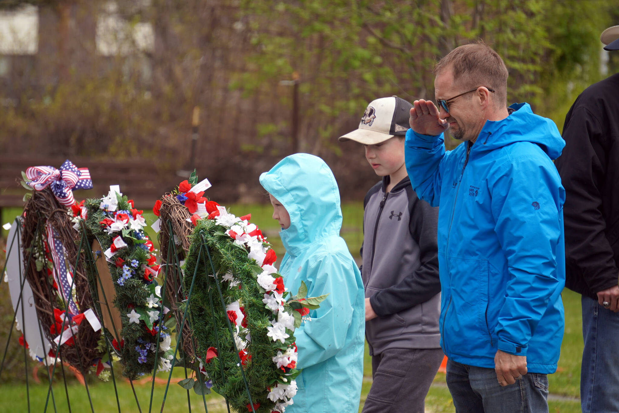 Poppies are affixed to wreaths during a Memorial Day ceremony at Leif Hanson Memorial Park in Kenai, Alaska, on Monday, May 27, 2024. (Jake Dye/Peninsula Clarion)