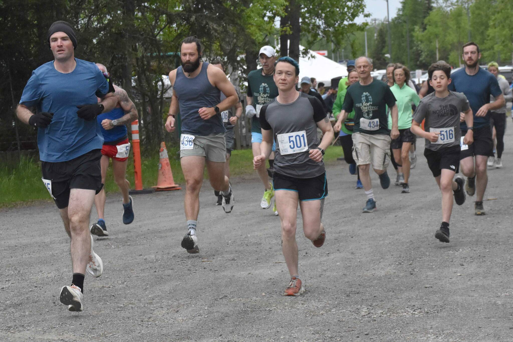 Lee Frey and Niko Zlotnik (501) lead the pack at the start of the 10-mile race at the Run for the River on Saturday, June 8, 2024, in Soldotna, Alaska. (Photo by Jeff Helminiak/Peninsula Clarion)