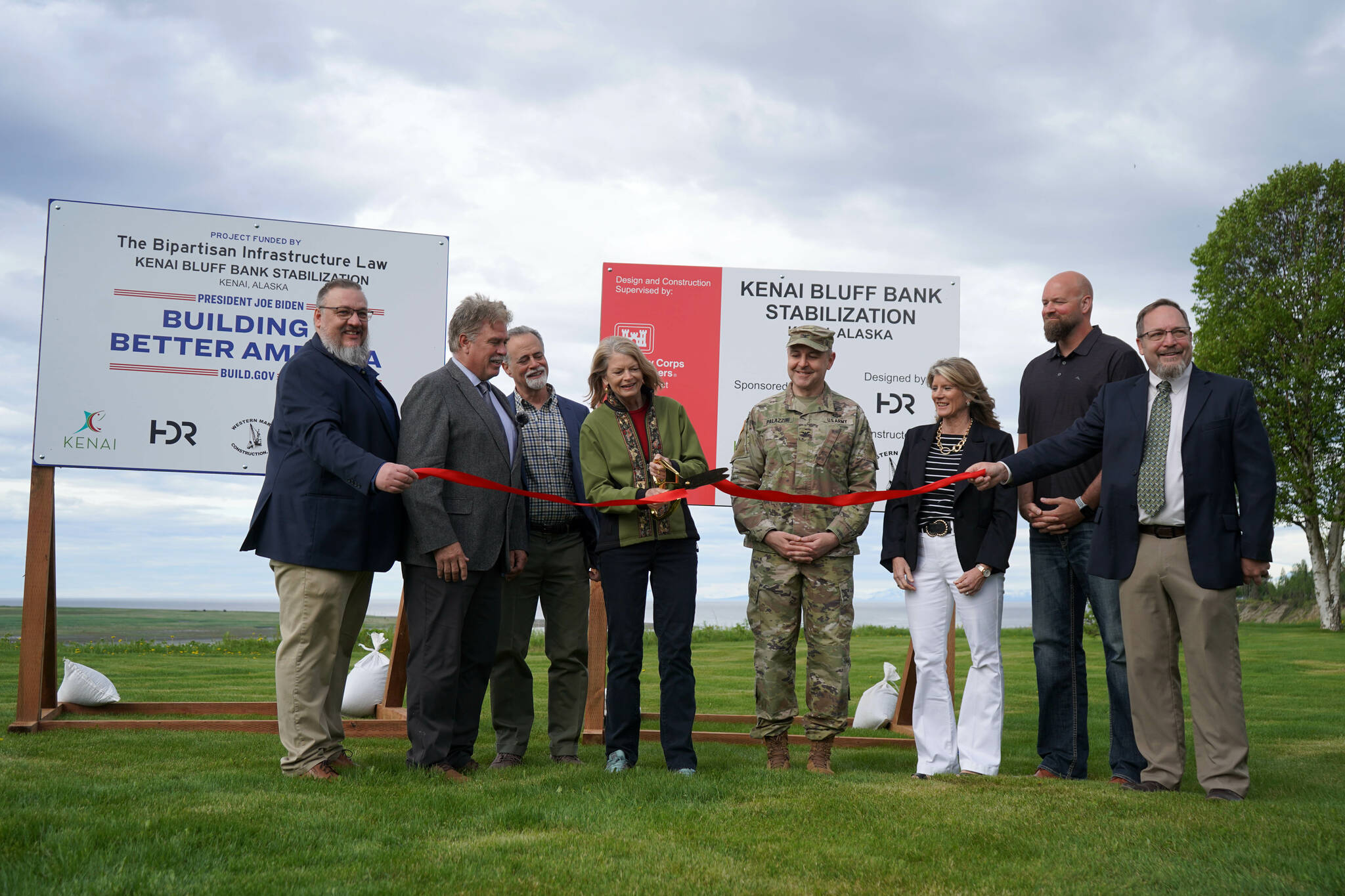 City of Kenai Public Works Director Scott Curtain, City of Kenai Mayor Brian Gabriel, Kenai Peninsula Borough Mayor Peter Micciche, Sen. Lisa Murkowski, Col. Jeffrey Palazzini, Elaina Spraker, Adam Trombley and Kenai City Manager Terry Eubank cut the ribbon to celebrate the start of work on the Kenai River Bluff Stabilization Project on the bluff above the Kenai River in Kenai, Alaska, on Monday, June 10, 2024. (Jake Dye/Peninsula Clarion)