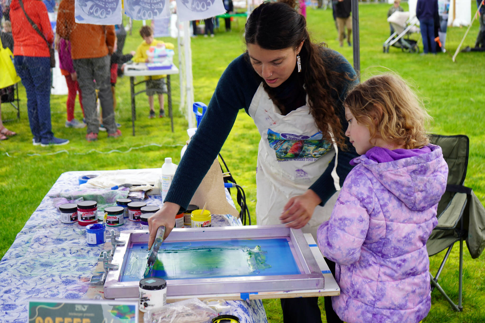 Children participate in a painting activity led by Cook Inletkeeper during the Kenai River Fair at Soldotna Creek Park in Soldotna, Alaska, on Saturday, June 7, 2024. (Jake Dye/Peninsula Clarion)